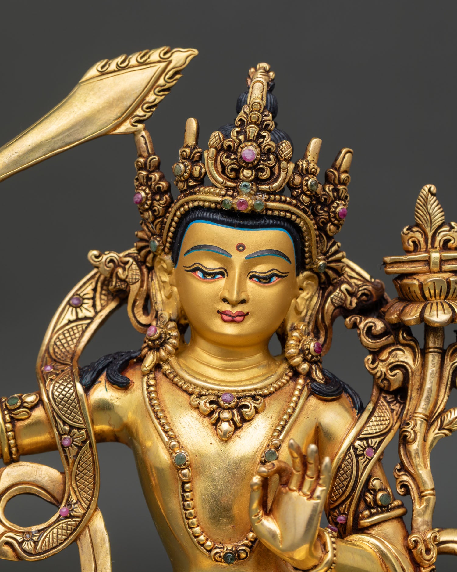 Close up of handmade Manjushri statue with detailed repoussé work