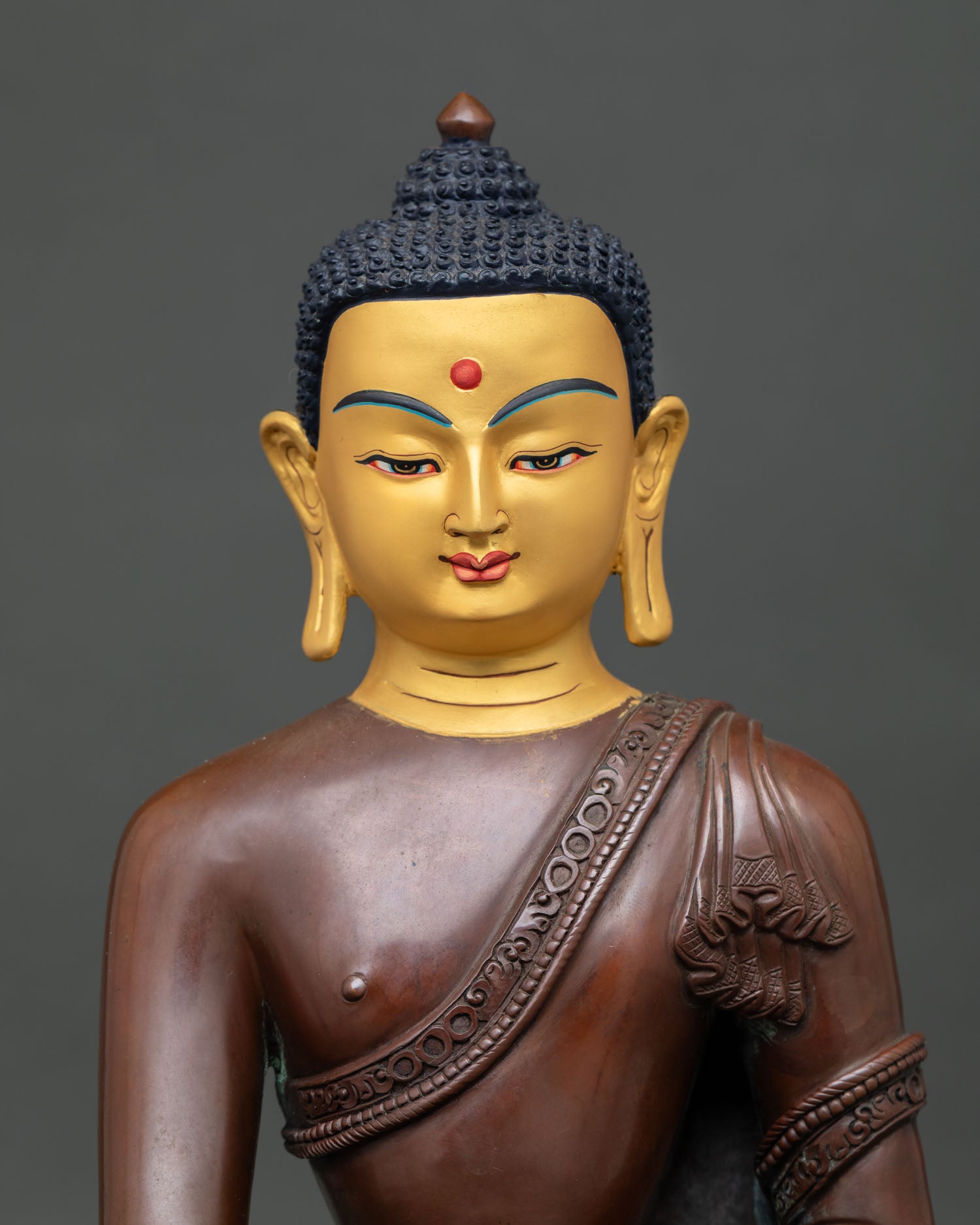 close up of handmade shakyamuni buddha statue with oxidized copper finish