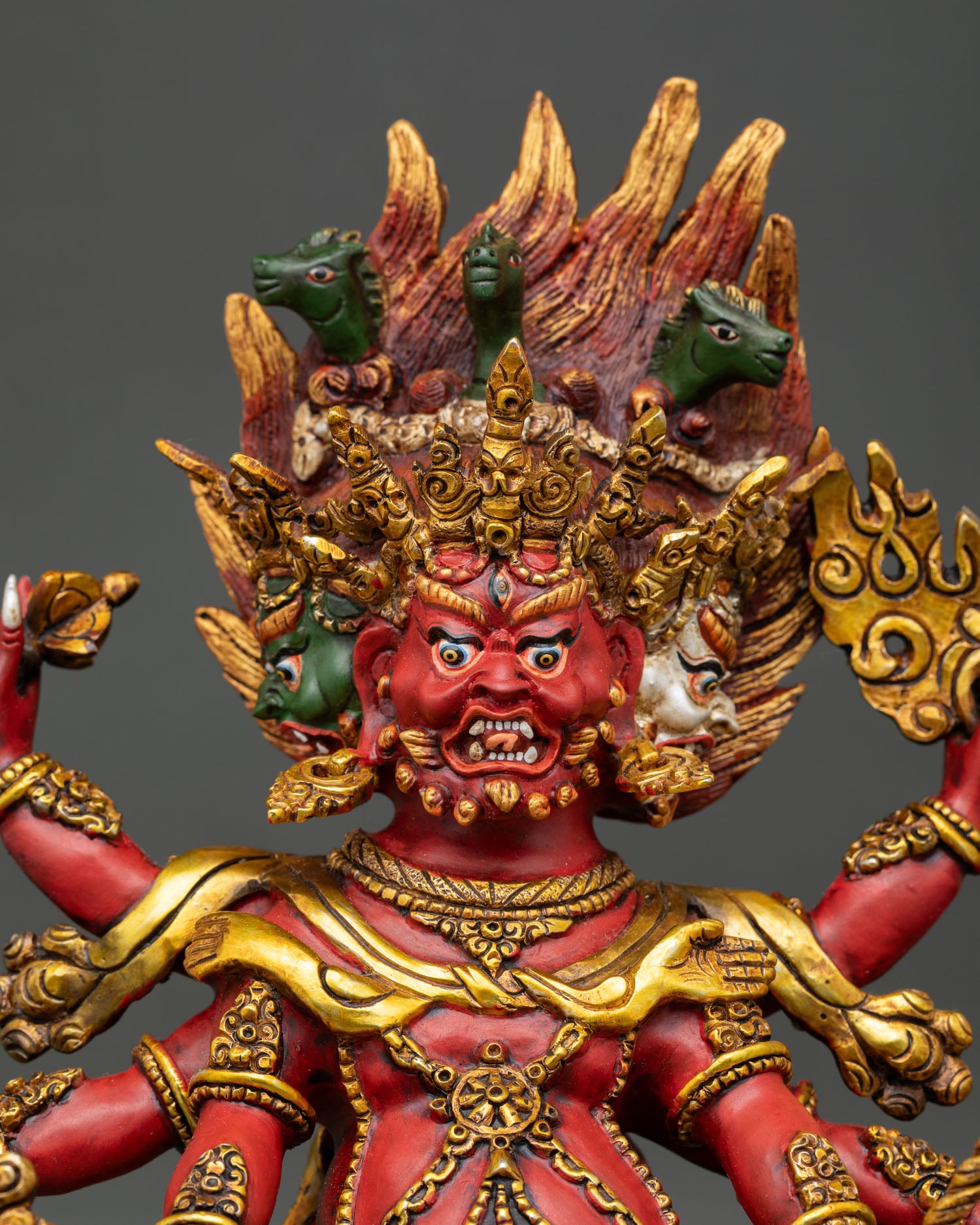 Close-up of Hayagriva Buddhist deity statue showing fierce expression, intricate facial details, and traditional Himalayan artistry.