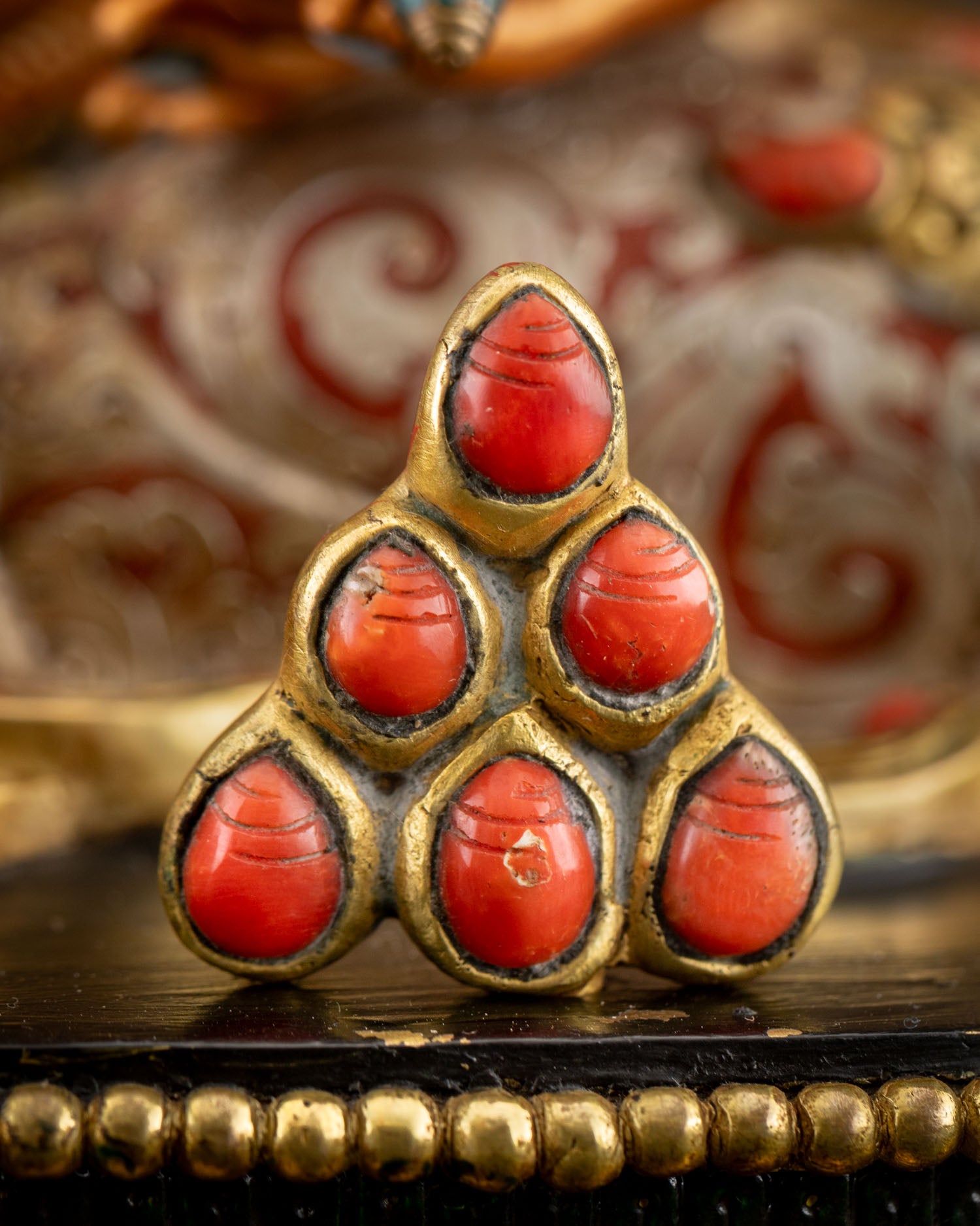 Close-up of jewels spitted by mongoose detail on Yellow Dzambhala statue
