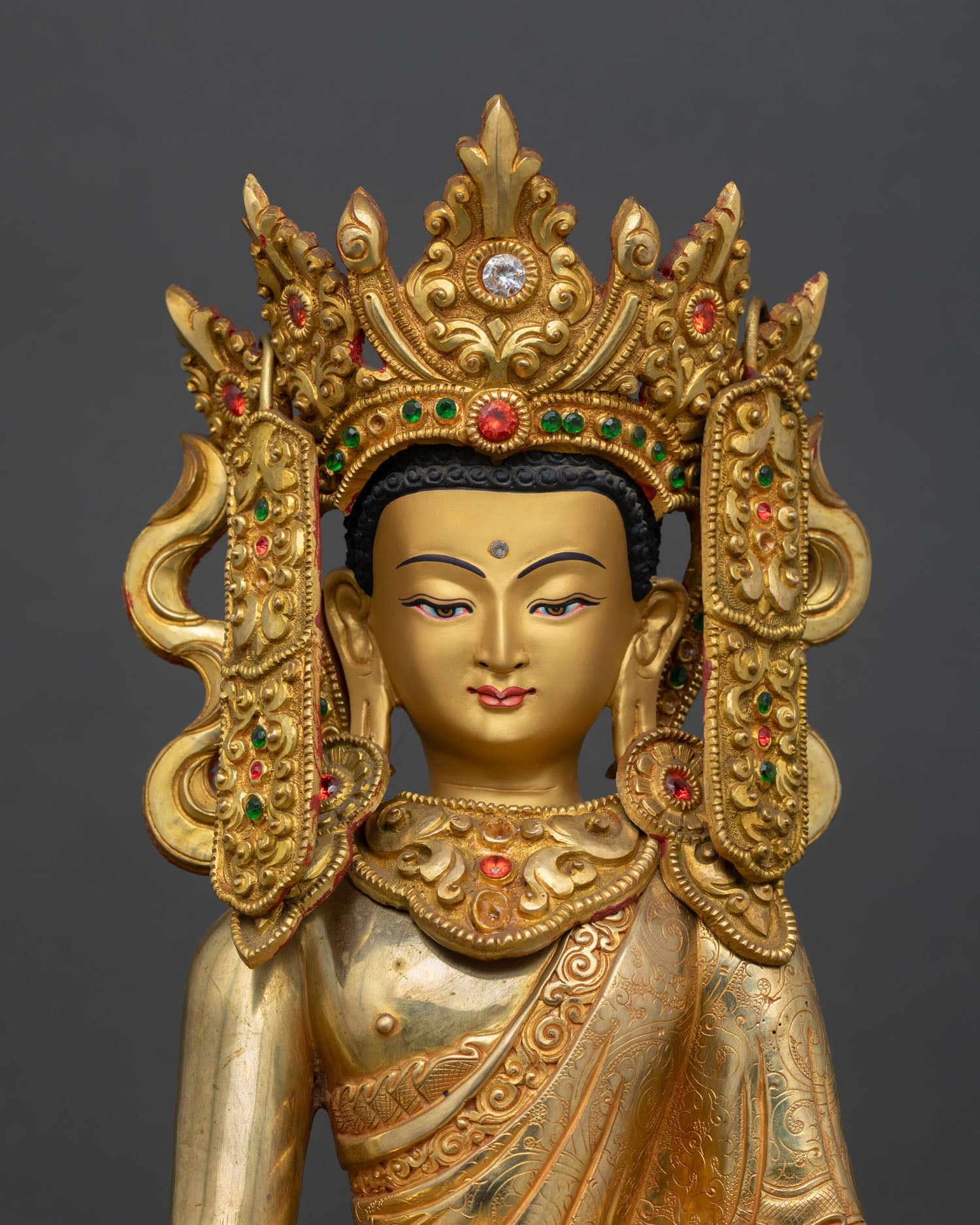 Close-up of Jowo Shakyamuni Rinpoche Statue showing serene gold painted face, five jeweled crown, and intricate Newari craftsmanship.