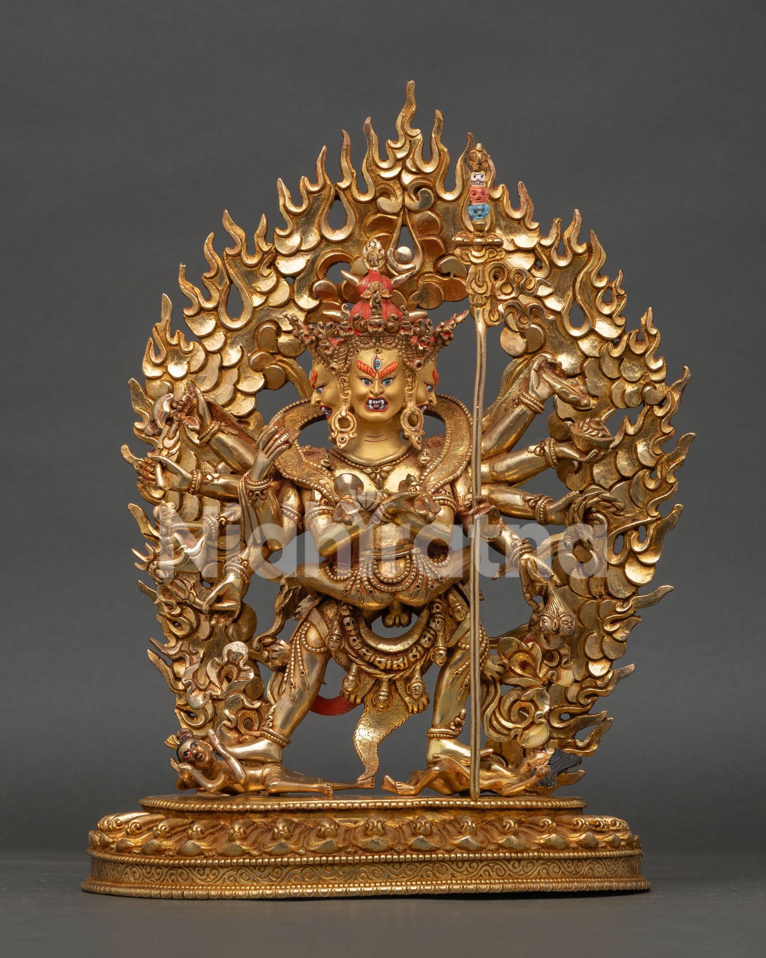 close up of kalachakra buddhist statue showing intricate gold gilded details