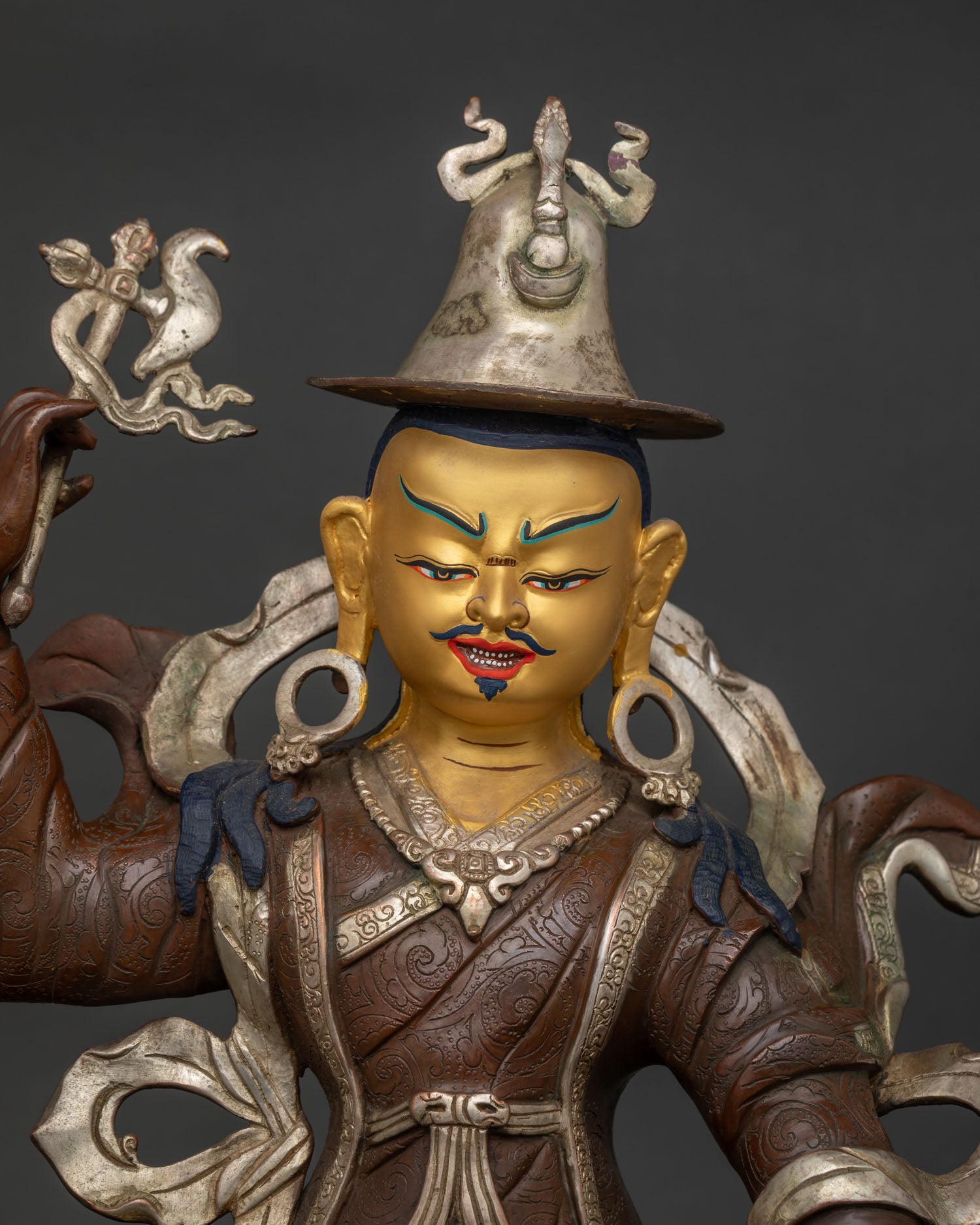 Close Up of King Gesar Warrior Statue with Gold Painted Face and Intricate Details