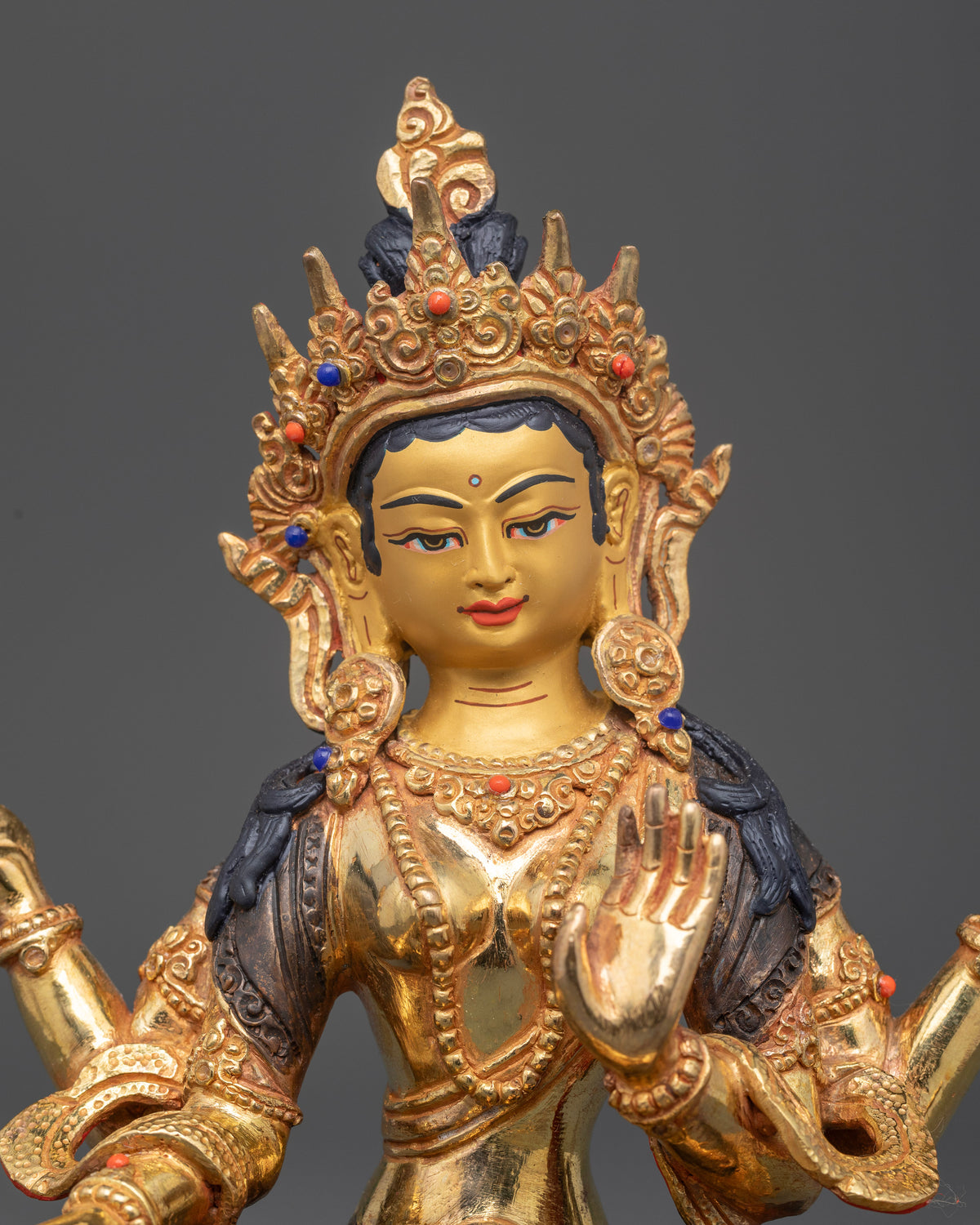 Close-up of Laxmi Goddess Statue showing gold-painted face, intricate ornaments, and traditional Nepalese metalwork