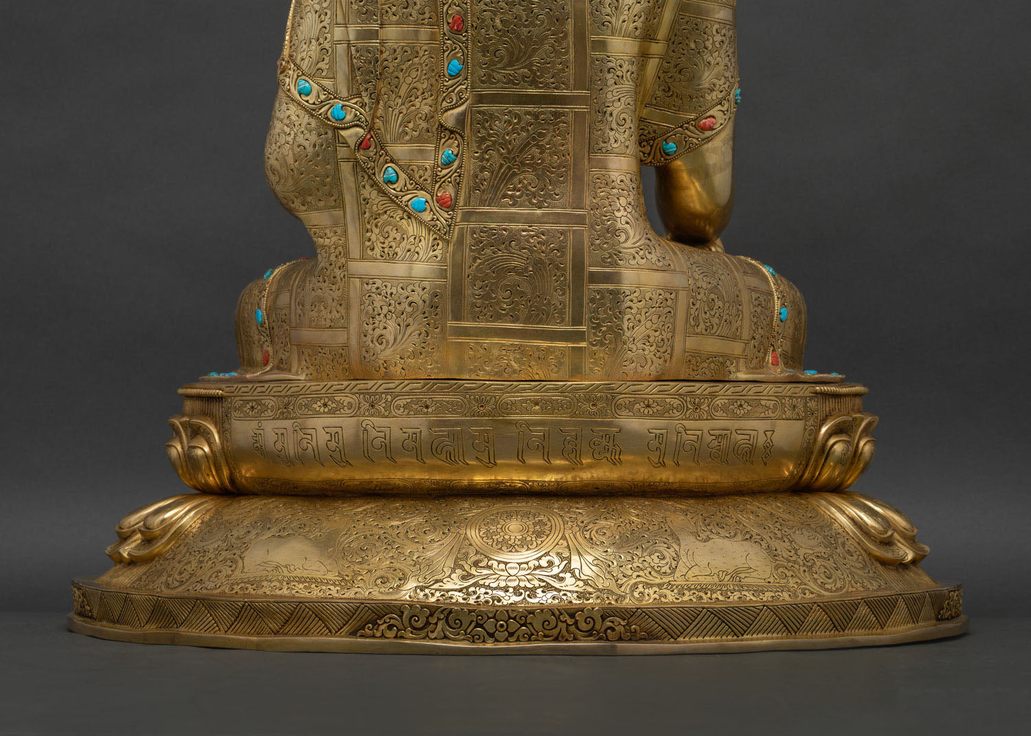 Close-up of lotus pedestal engraved with Om Muni Muni Mahamuni mantra