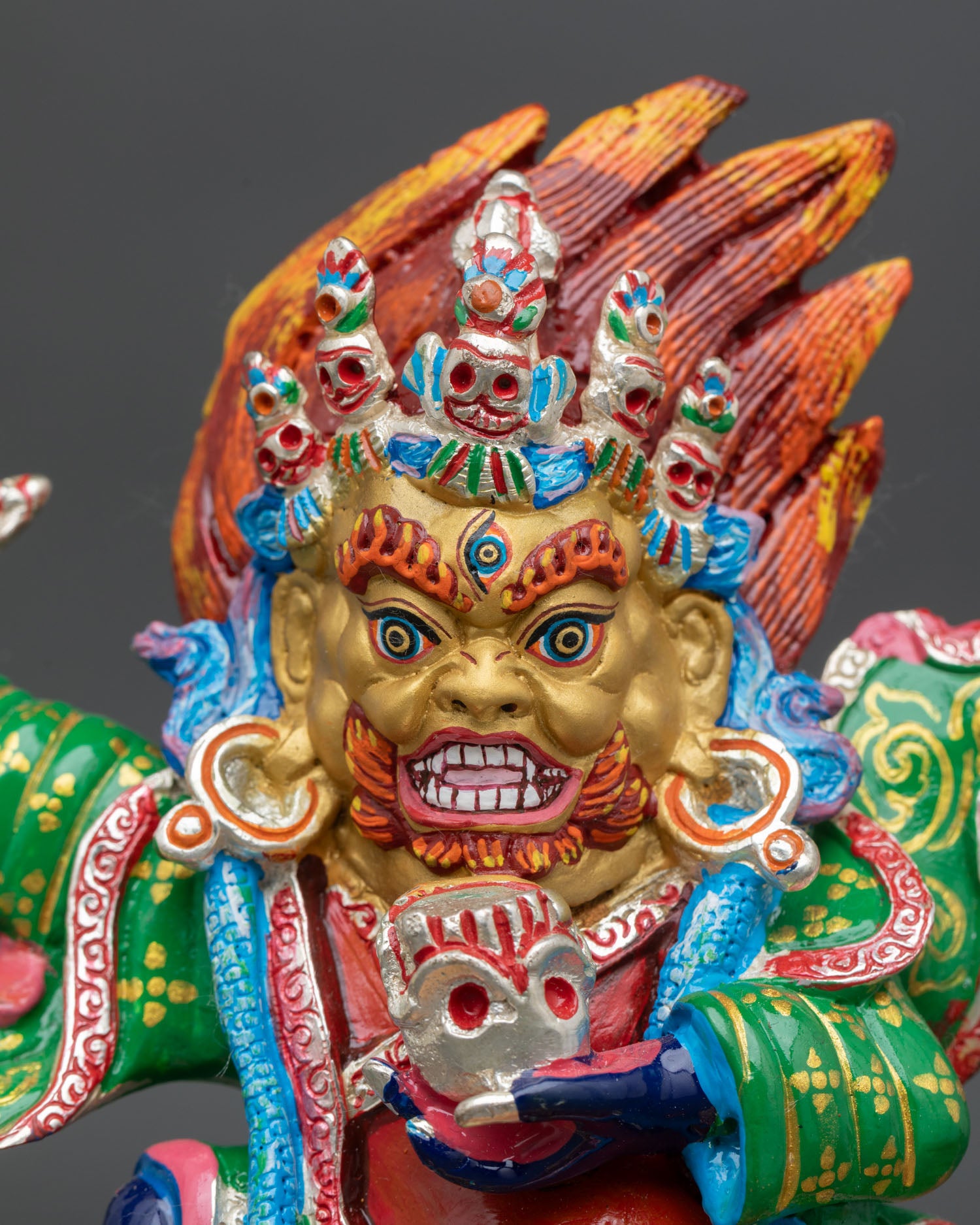 close up of mahakala bernagchen statue with skull cup and flaying knife details