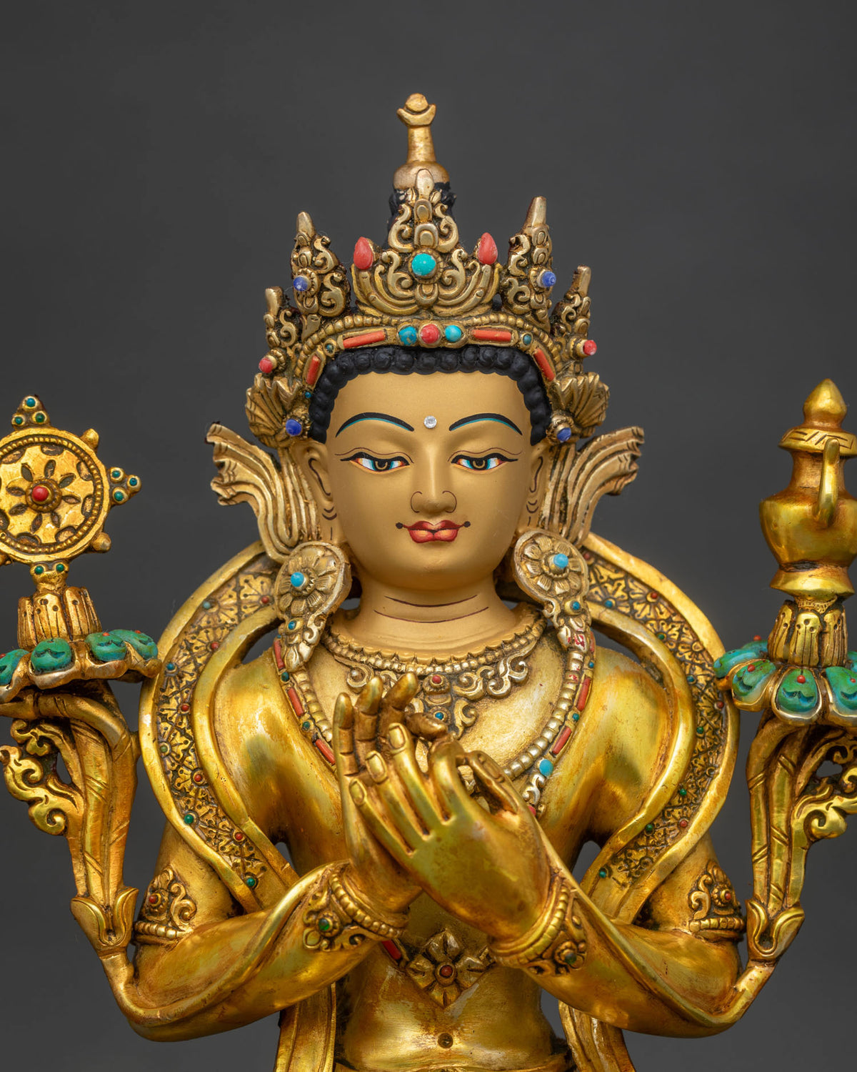 Close-up of Maitreya Buddha statue showing crown, robes and throne details