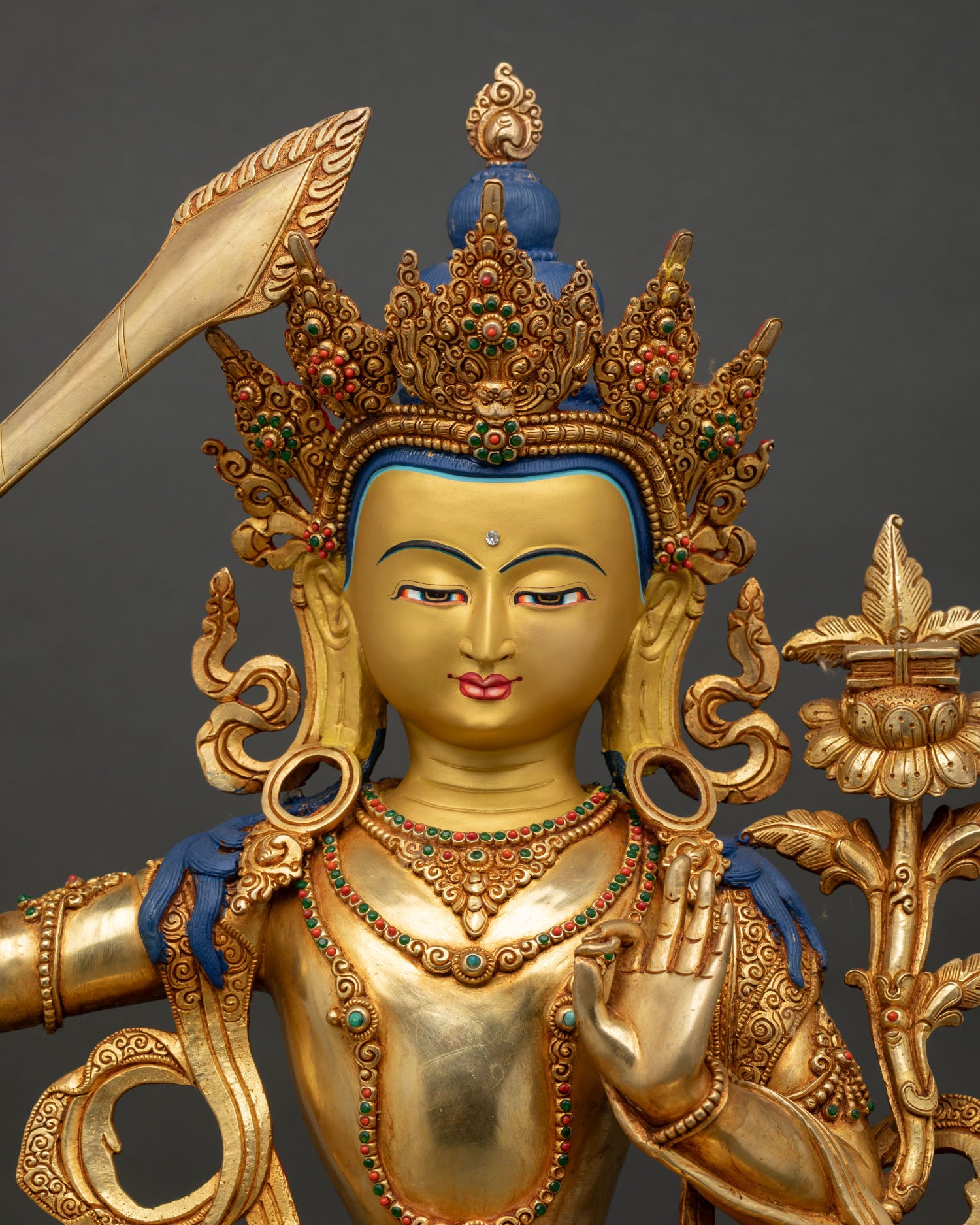 close-up of manjushri bodhisattva face with golden details and wisdom expression