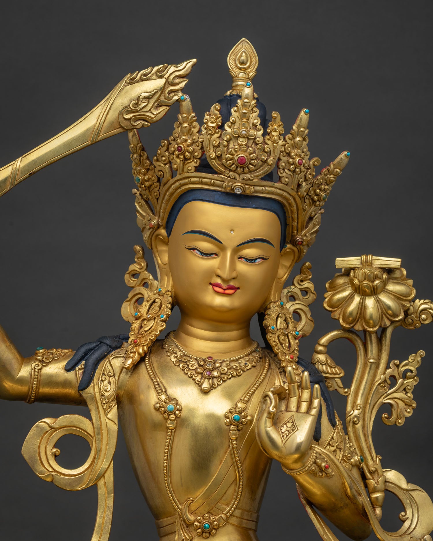 Close up of Manjushri Copper Statue showing gold fire gilding and lotus pedestal detail