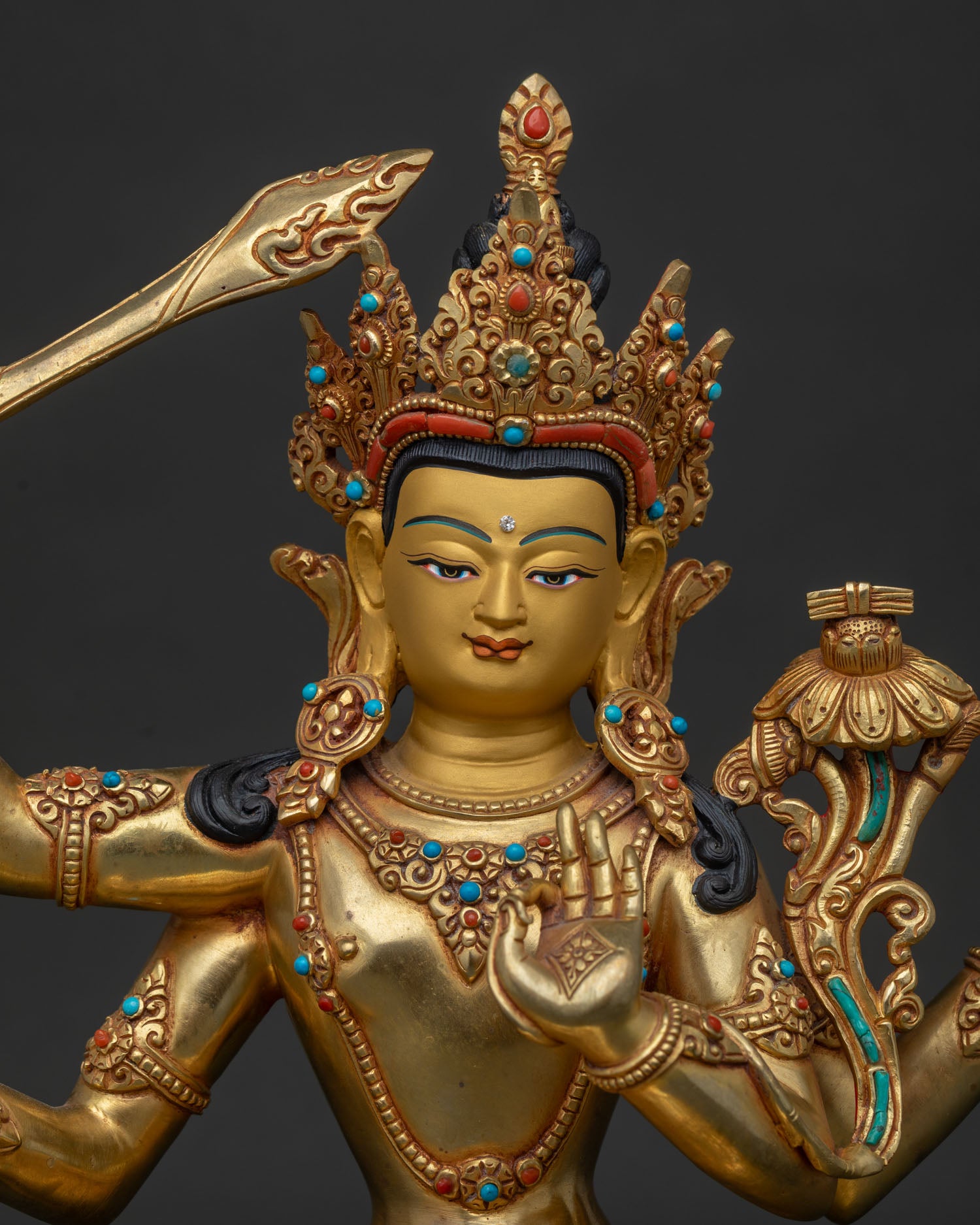 Close up of Namasangiti Maha Manjushri Statue with gold gilding and gemstone details