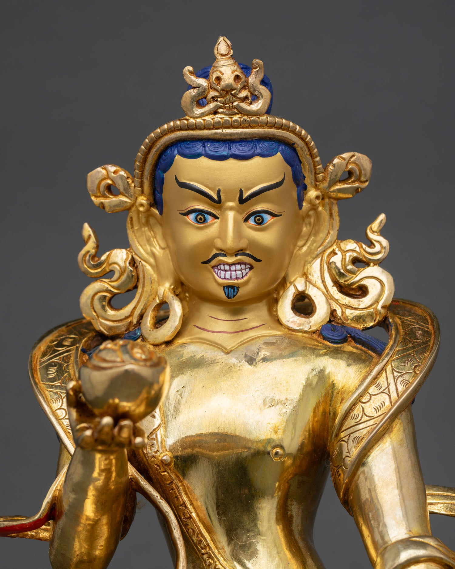 close up of naropa buddhist statue showing intricate copper carvings and sacred details