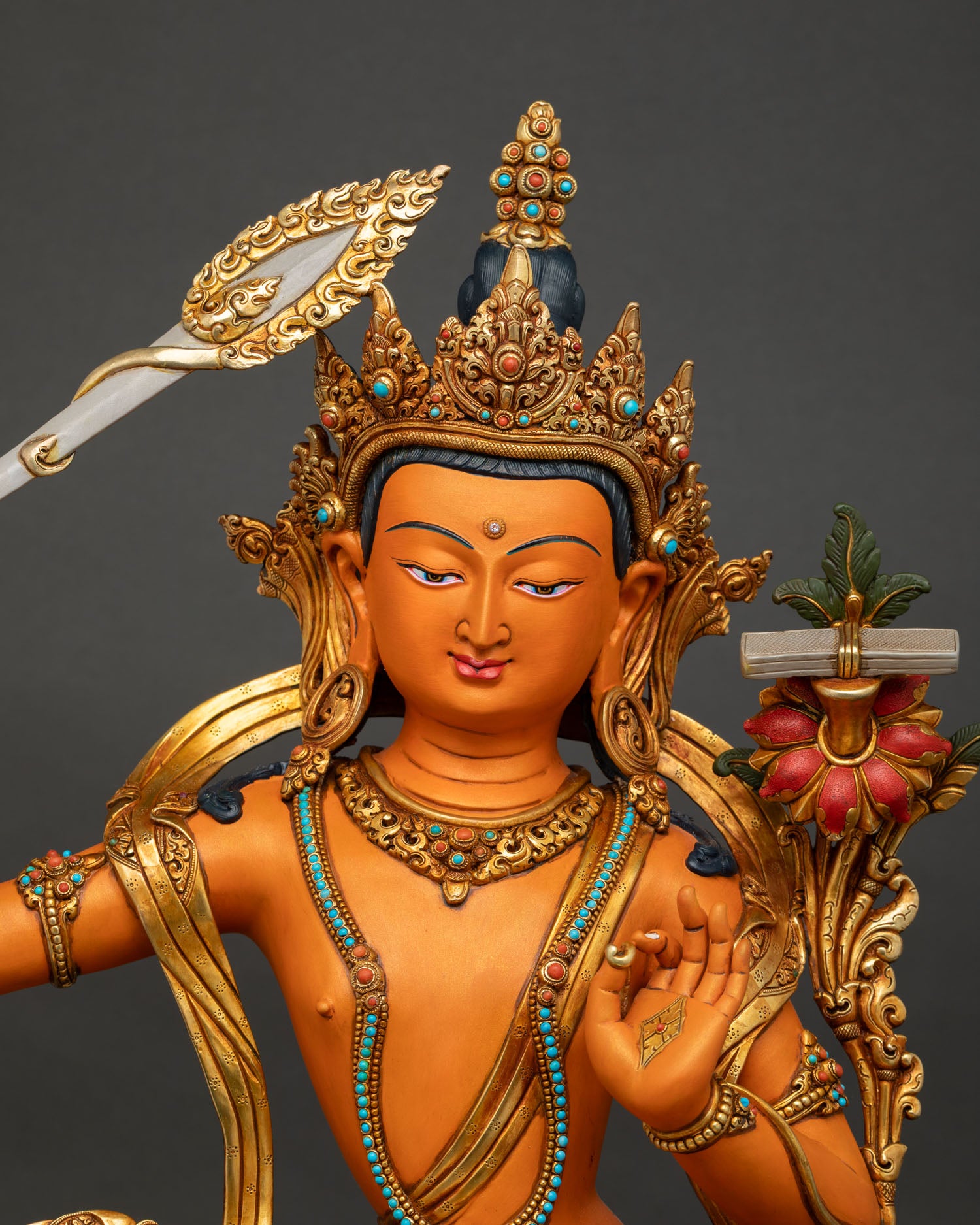 Close-up of Nepal-made Manjushri Statue highlighting acrylic colors and intricate 3D carvings