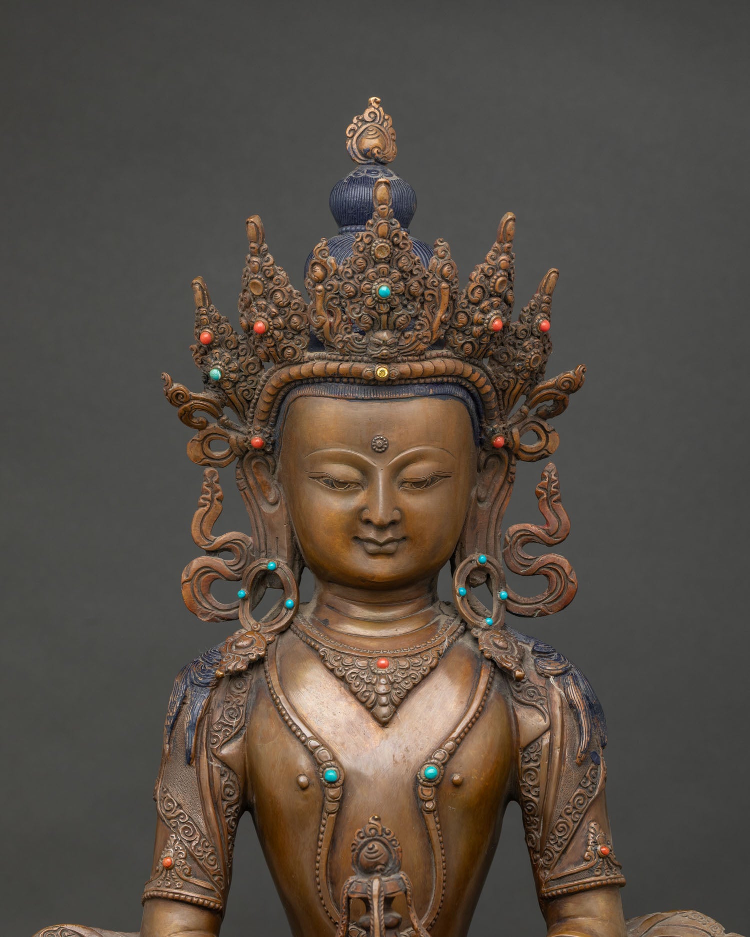 Close-up of oxidized copper Amitayus statue showing crown, jewelry and kalasha detail