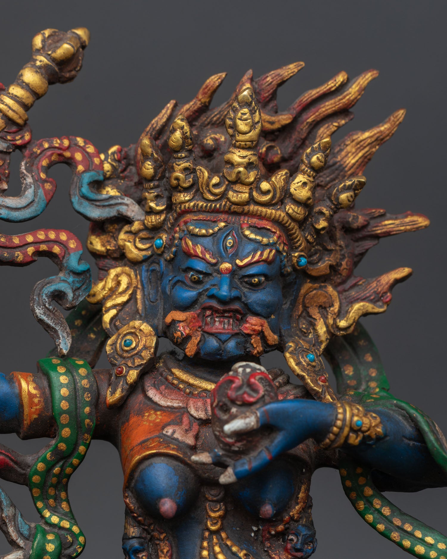 Close up of palden lhamo face skull cup staff and blazing halo detail