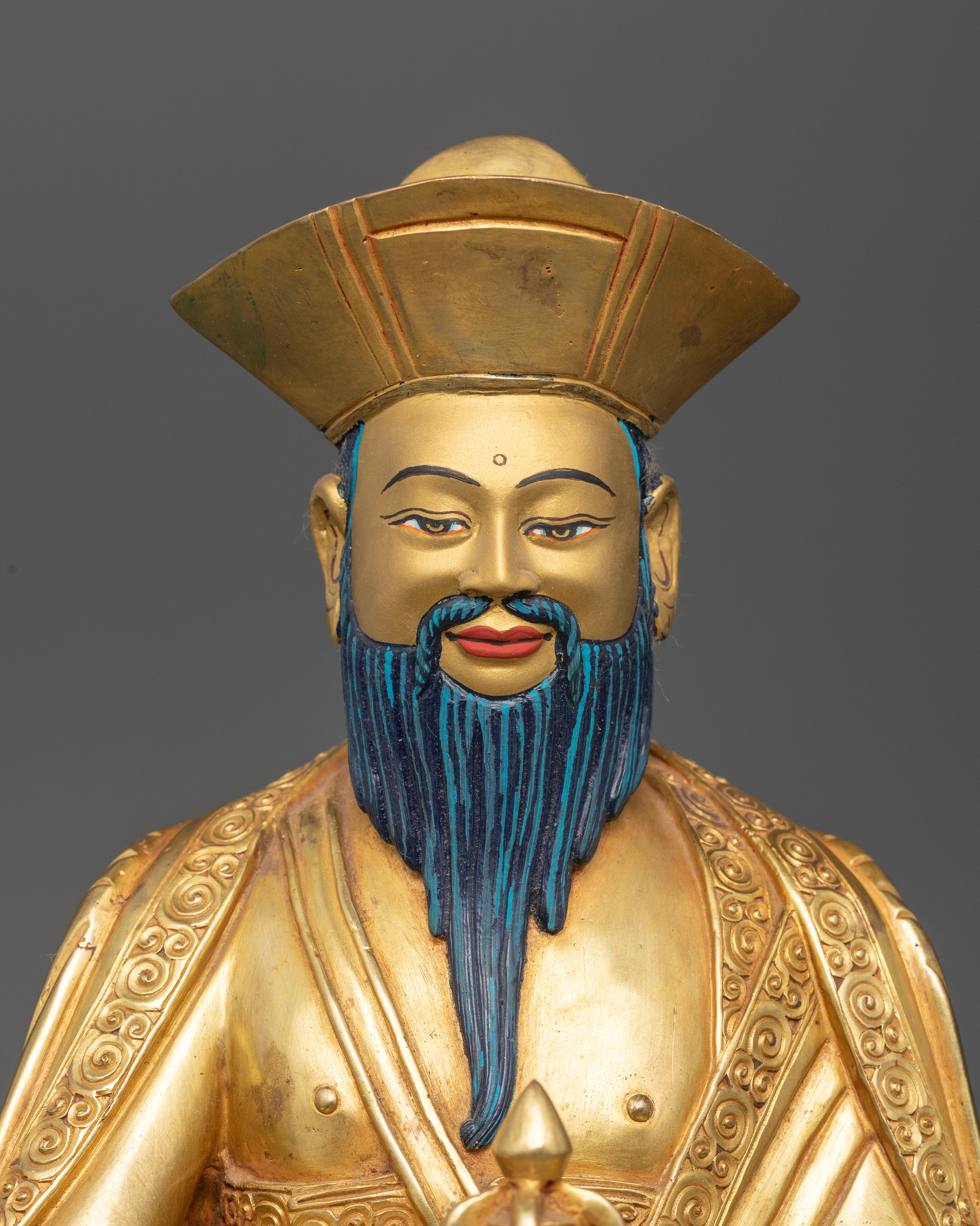 Close up of Shabdrung Ngawang Namgyal statue showing copper craftsmanship and gold gilding