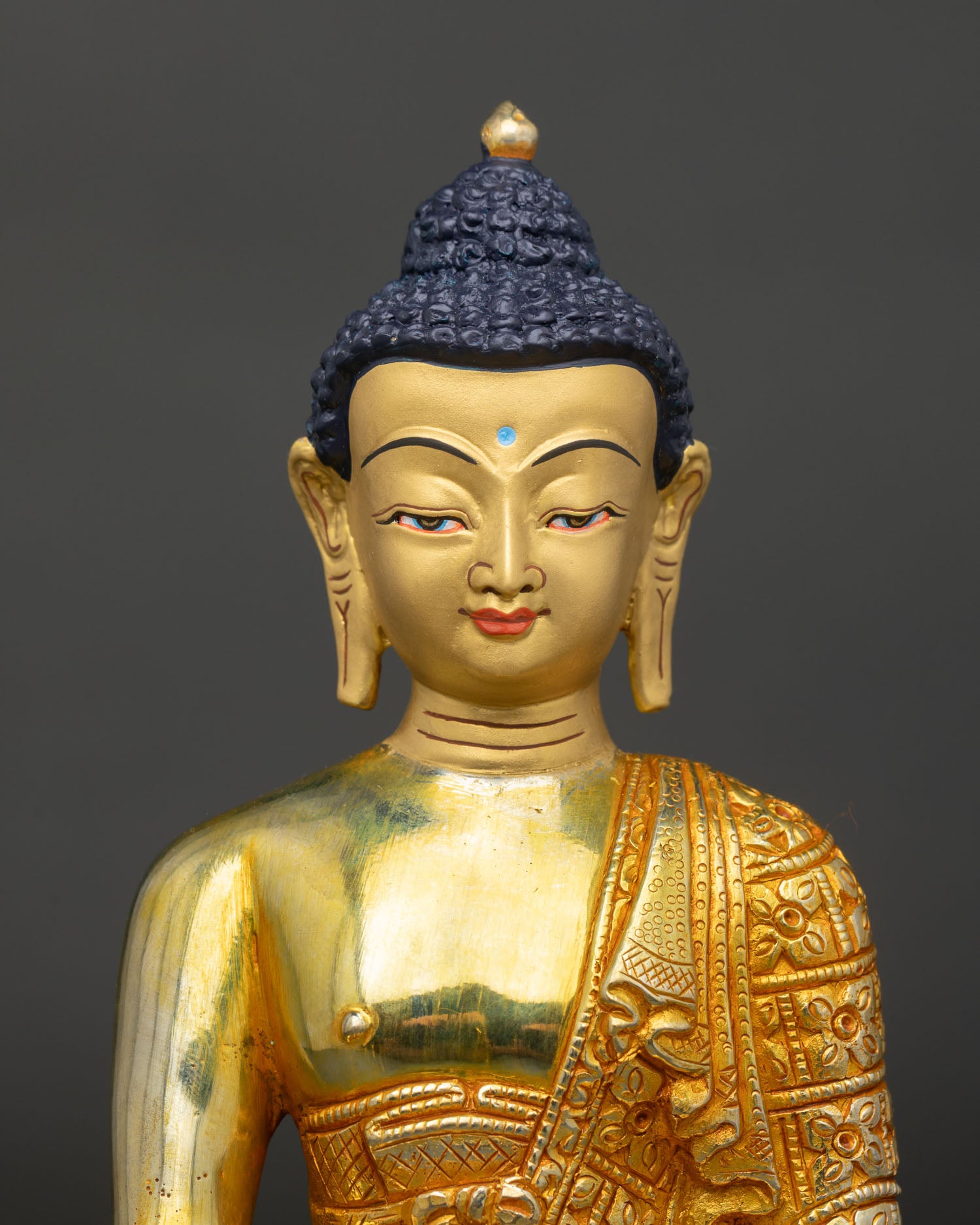 Close Up of Shakyamuni Buddha Gold Painted Face with Floral Monk Robe.