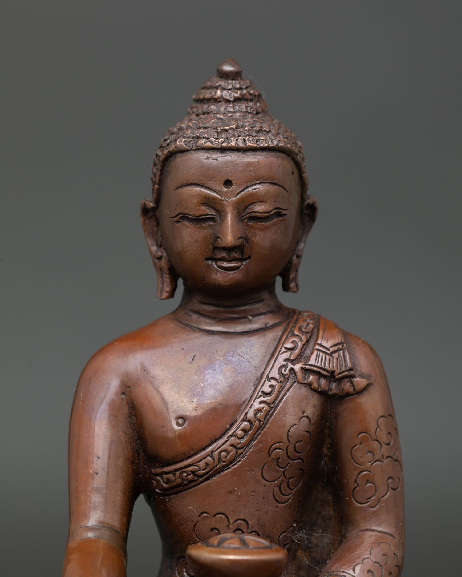 Close Up of Shakyamuni Buddha Showing Hand Carved Monk Robe and Copper Details.