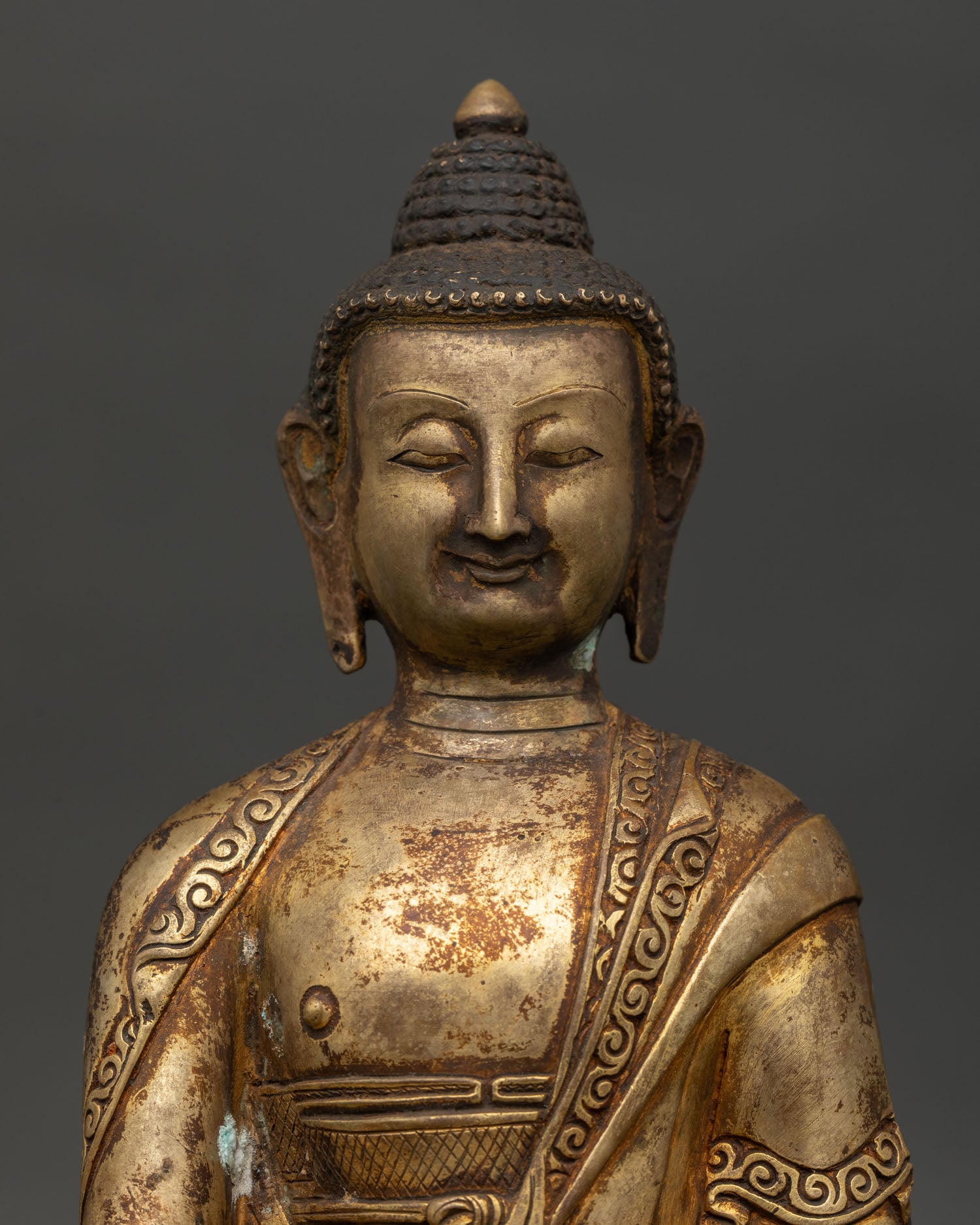 Close-up of Shakyamuni Buddha Statue in Bhumisparsha Mudra holding a begging bowl.