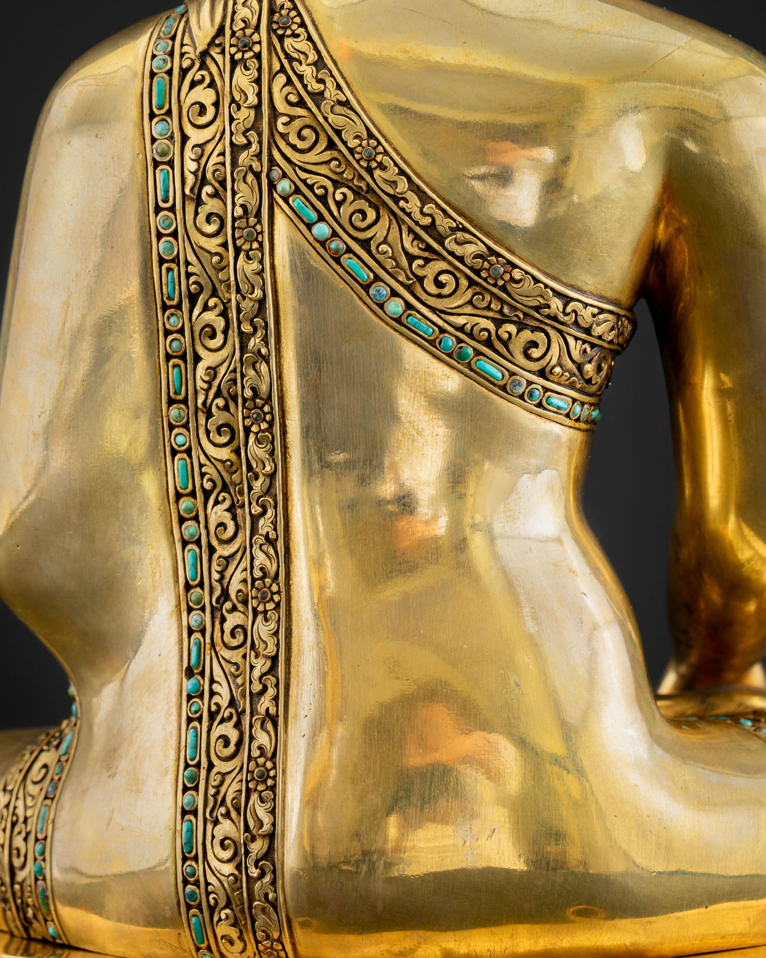 Close-up of Shakyamuni Buddha statue Kasaya robe with carved floral motifs and turquoise inlay