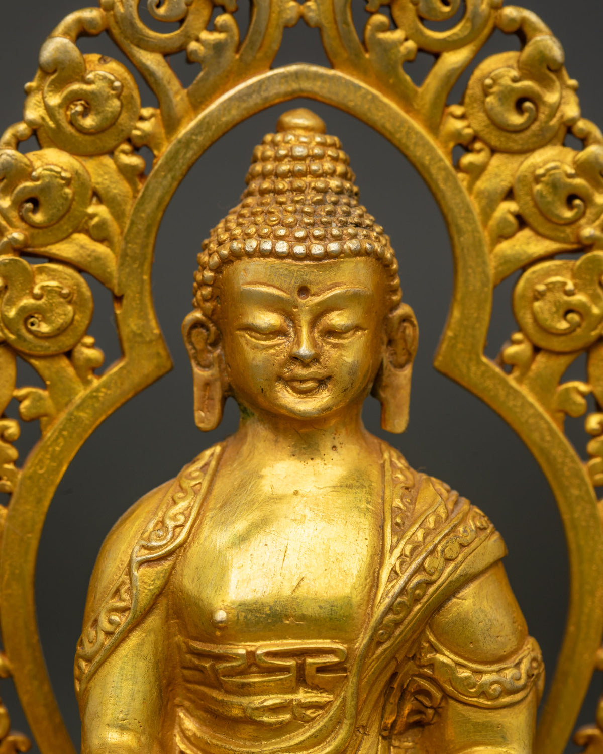 Close up of Shakyamuni Buddha statue showing bhumisparsha mudra and begging bowl.
