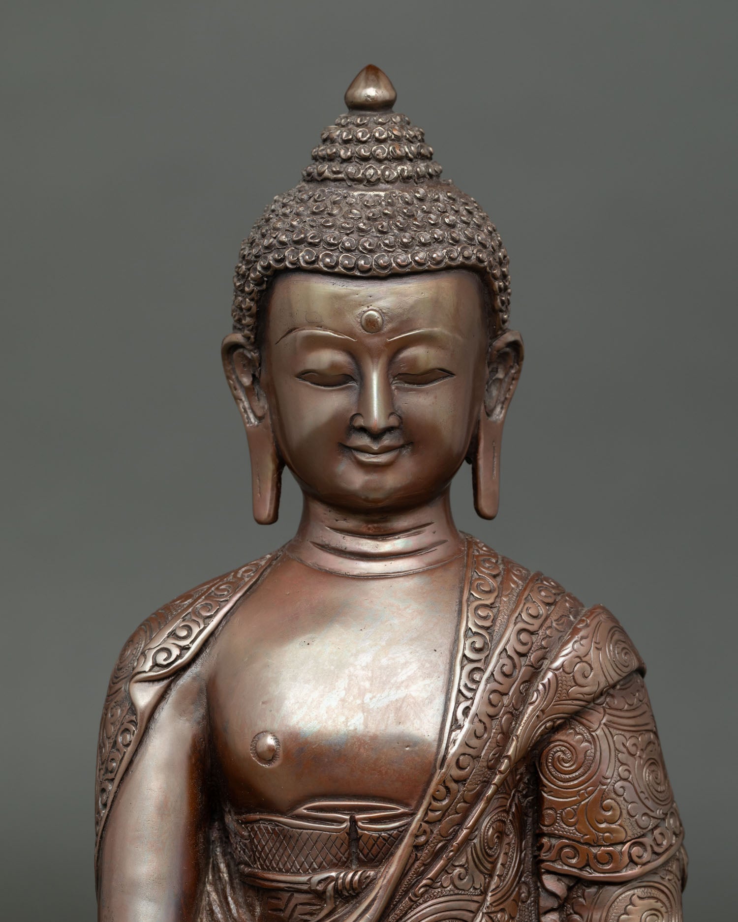 Close up of Shakyamuni Buddha statue with earth touching mudra and begging bowl