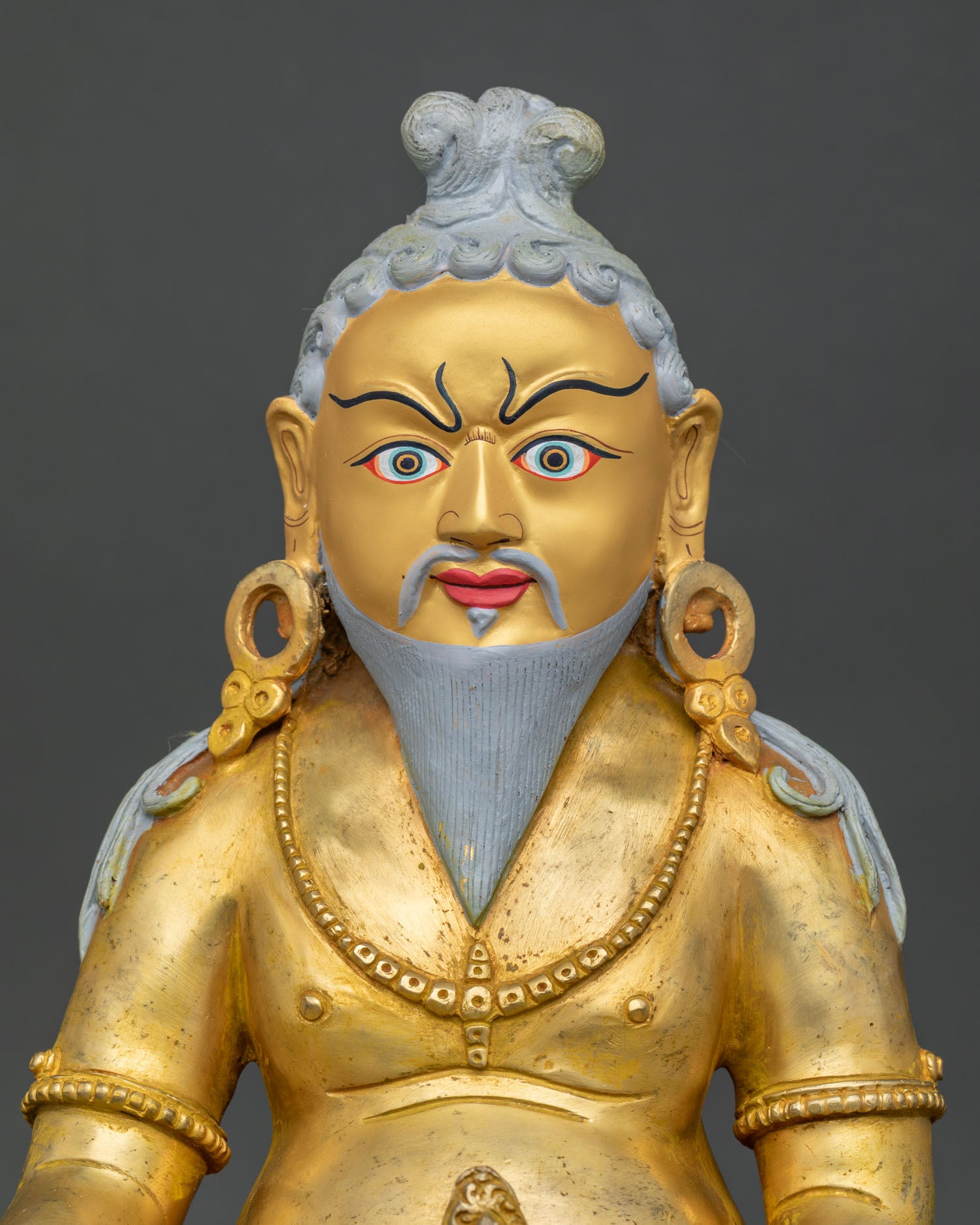 Close-up of Thang Thong Gyalpo Statue showing intricate gold-gilded copper details