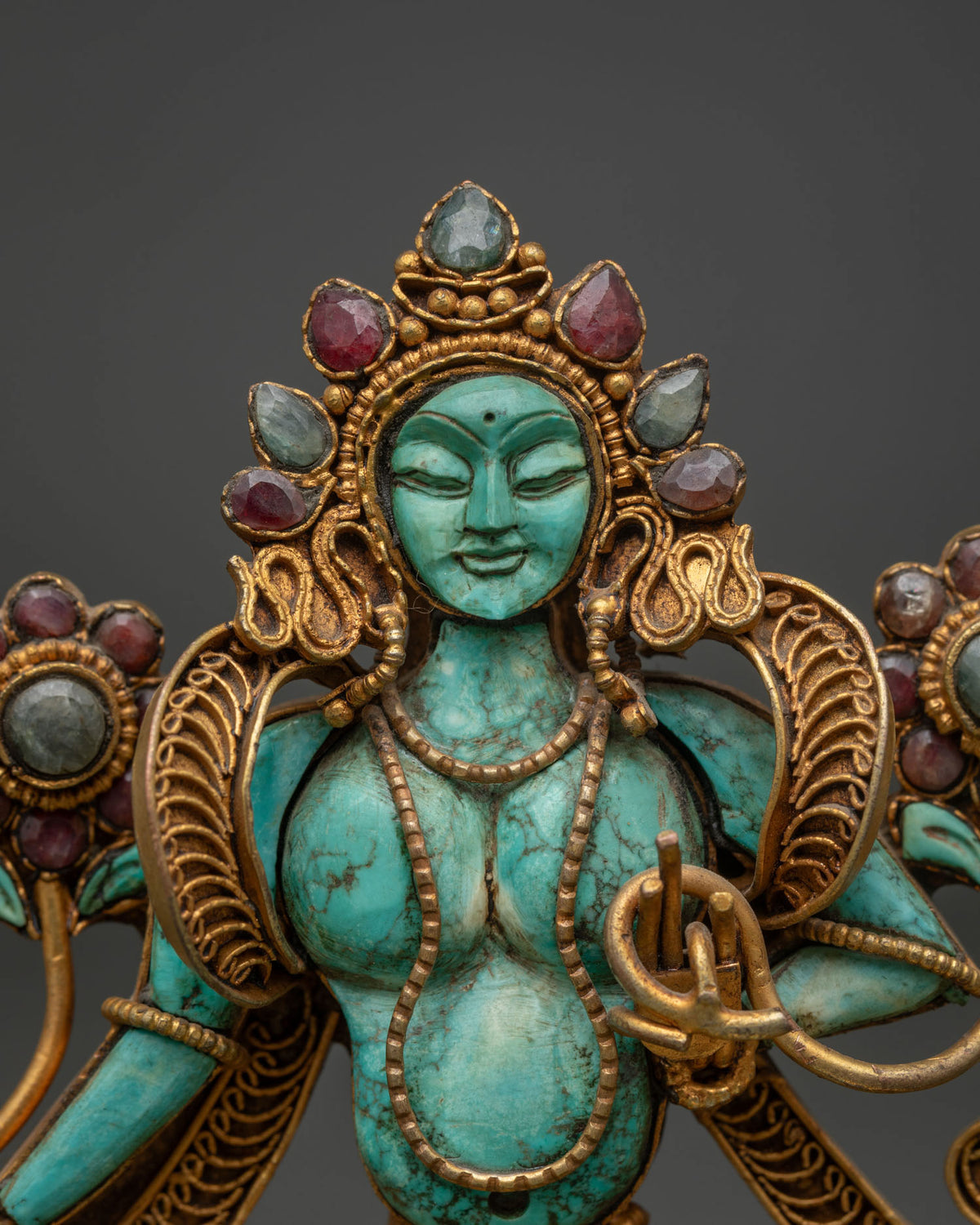 close up of turquoise green tara face and gemstone crown handcrafted by newari artists