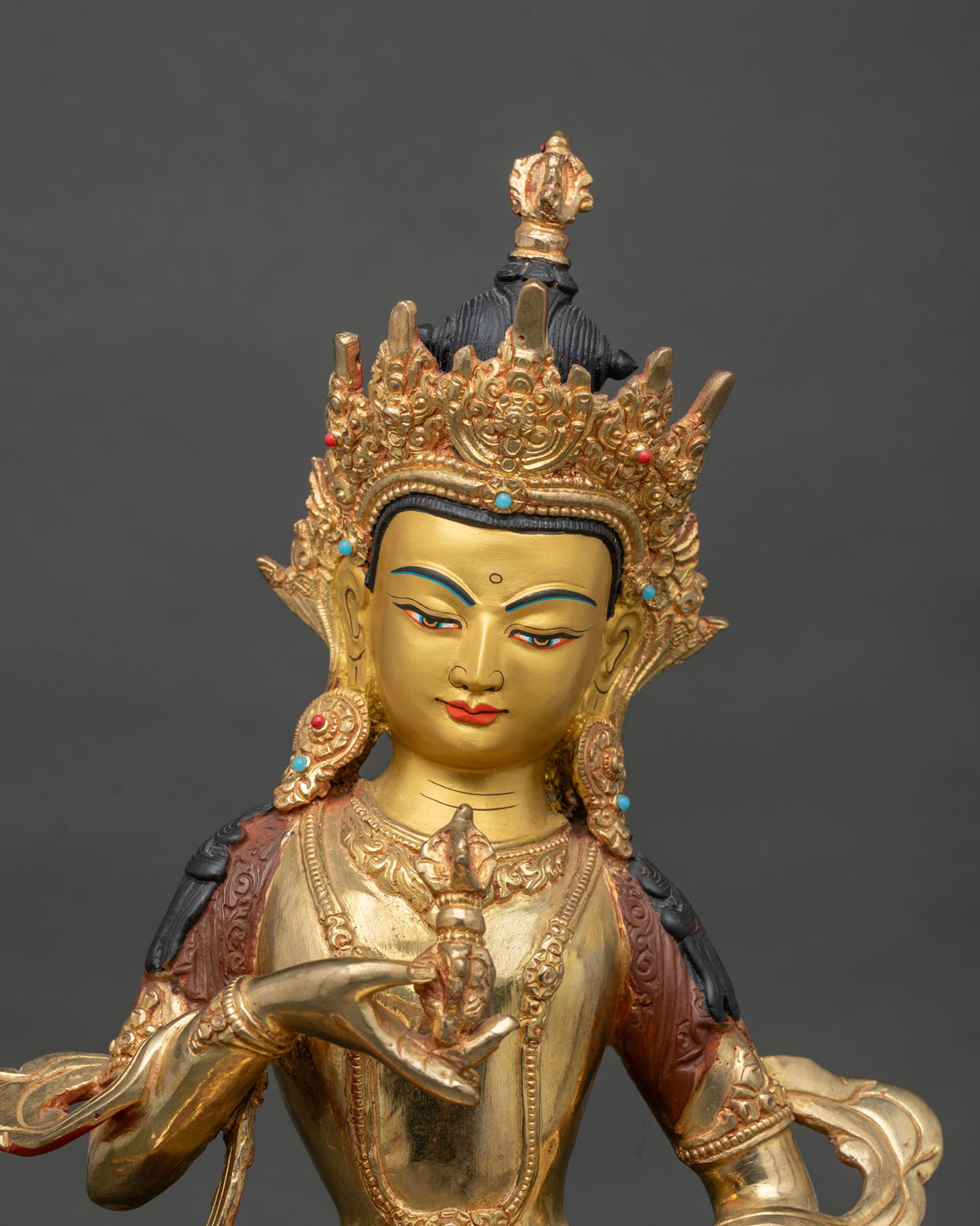 Close-up of Vajrasattva face and vajra with calm gilded expression and Five-Jewel Crown