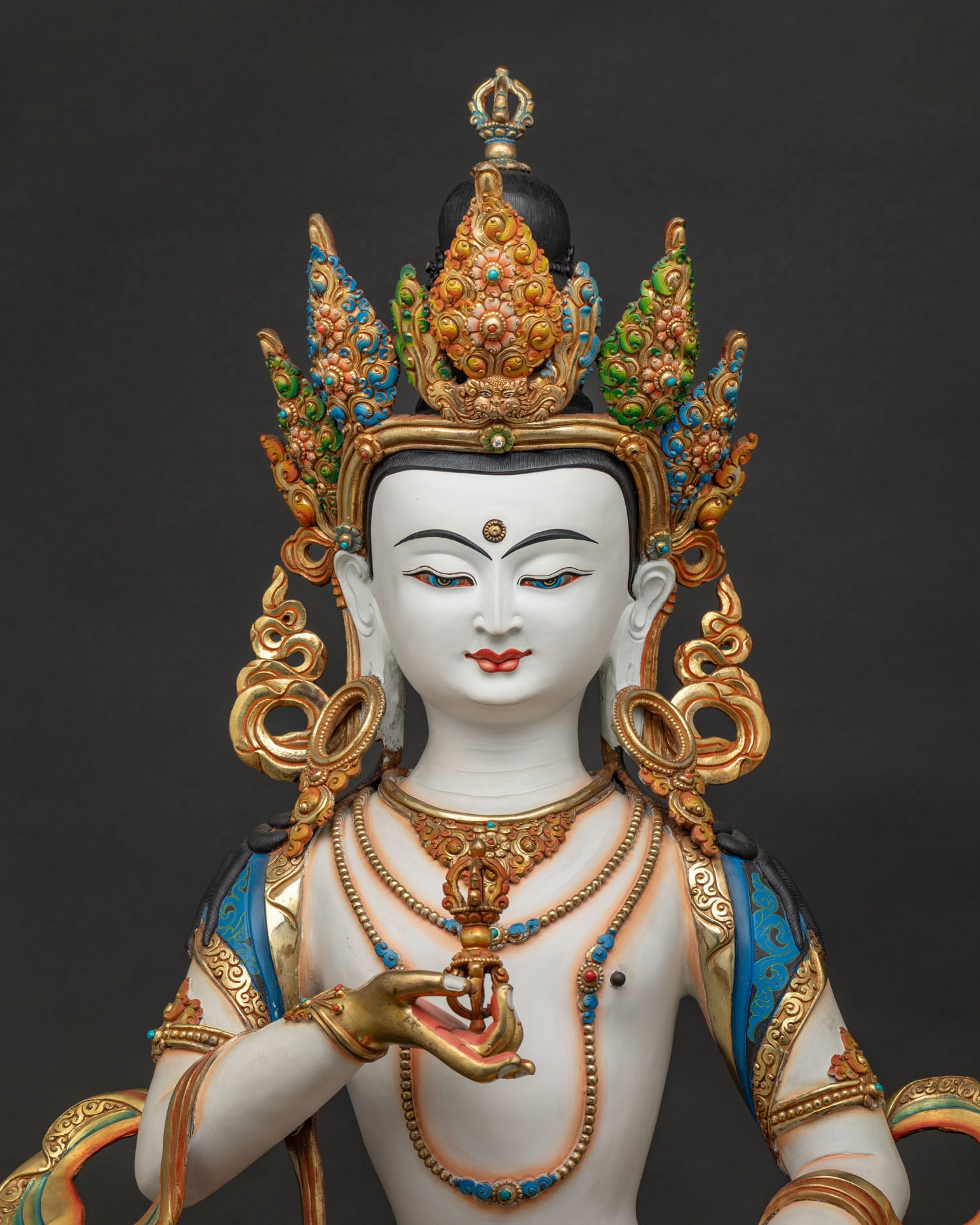 Close-up of Vajrasattva statue, gold-gilded copper Buddha sculpture with hand-painted detail