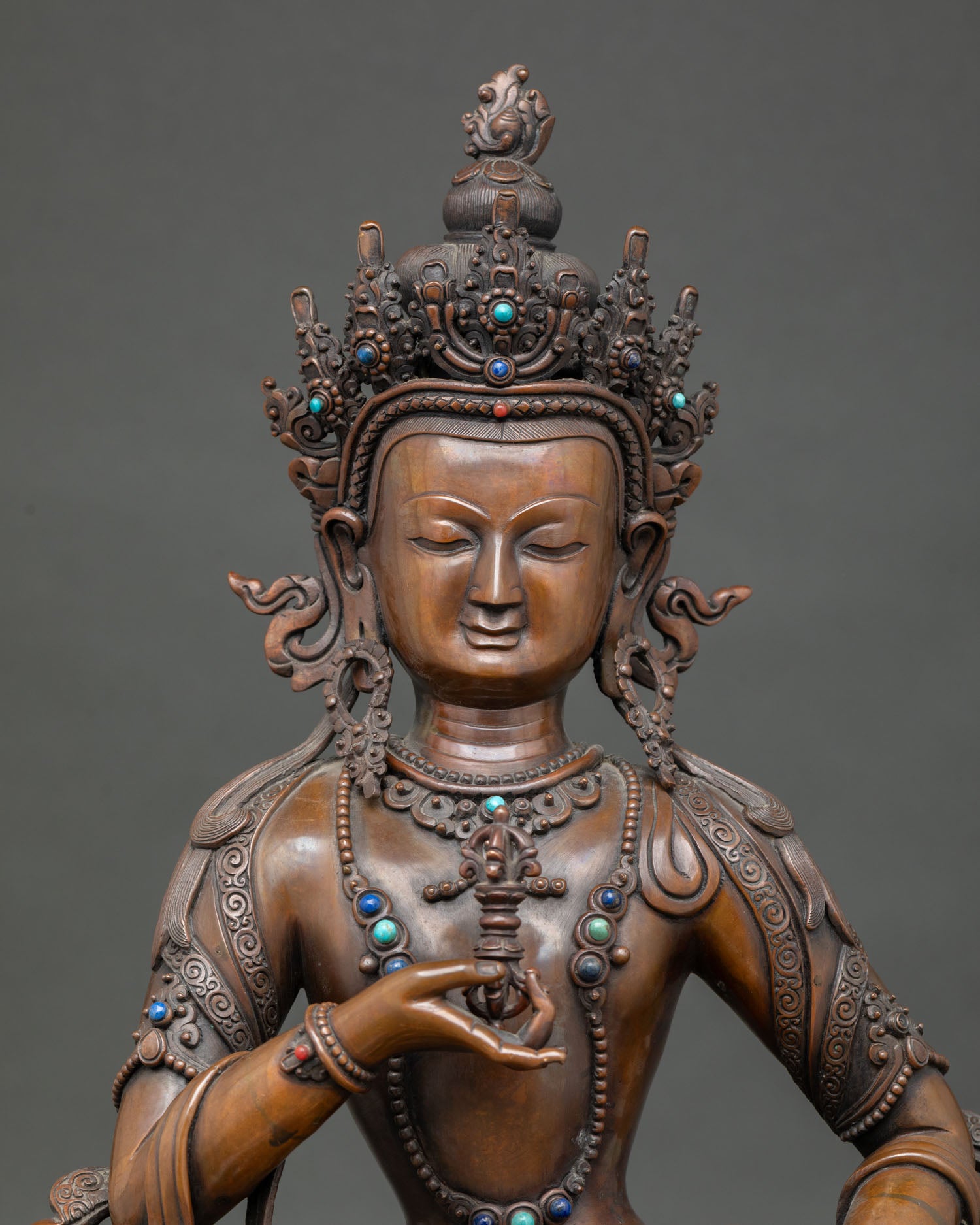 Close-up of Vajrasattva Statue Showing Serene Expression, Jeweled Crown, and Intricate Buddhist Details.