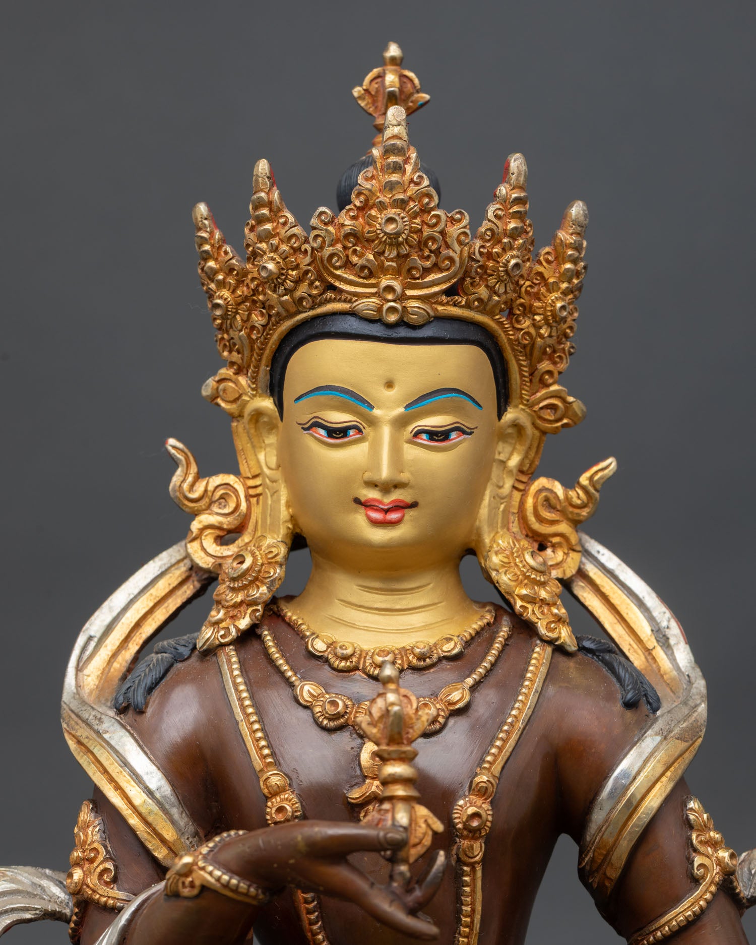 close-up of vajrasattva statue with silver accents and sacred vajra symbolism