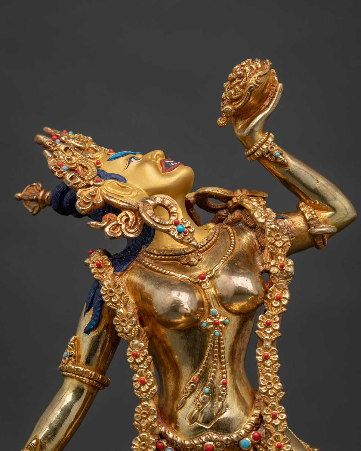 Close-up of Vajrayogini statue showing gold gilding and turquoise coral stones