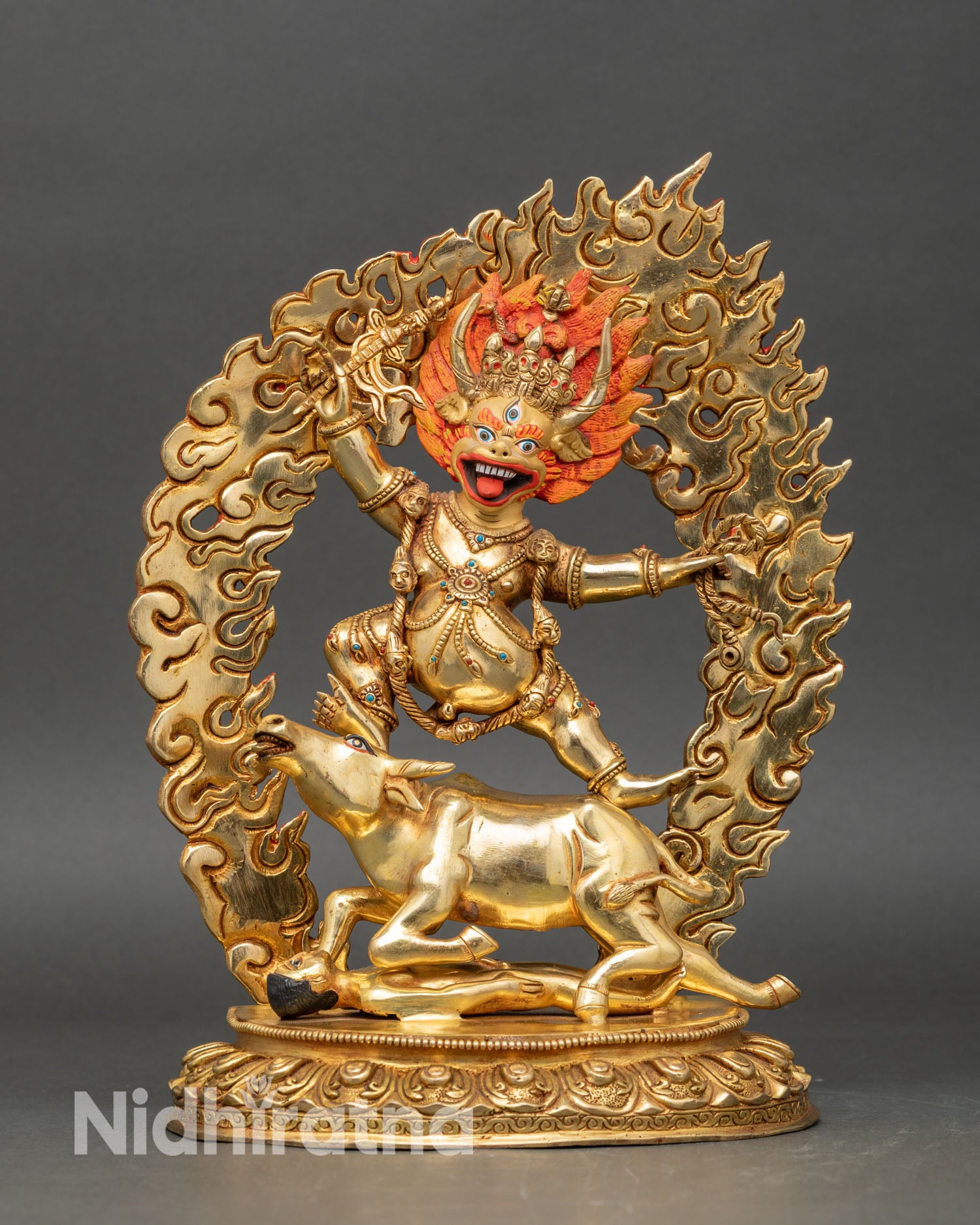 Close up of Yamantaka statue showing gold-painted face, wrathful deity, and sacred Buddhist art details