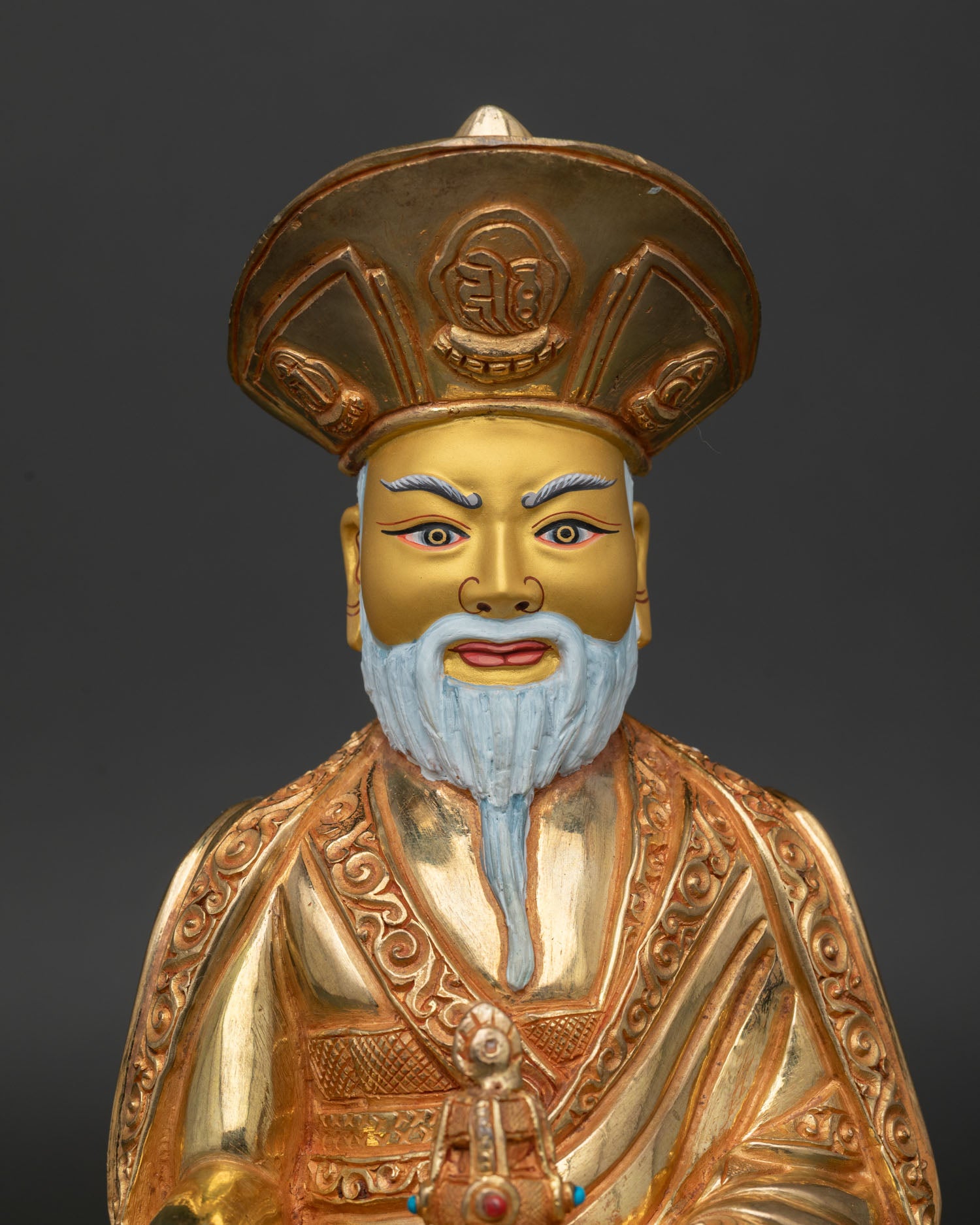 Close Up of Zhabdrung Ngawang Namgyal Gold Painted Face and Lama Hat.