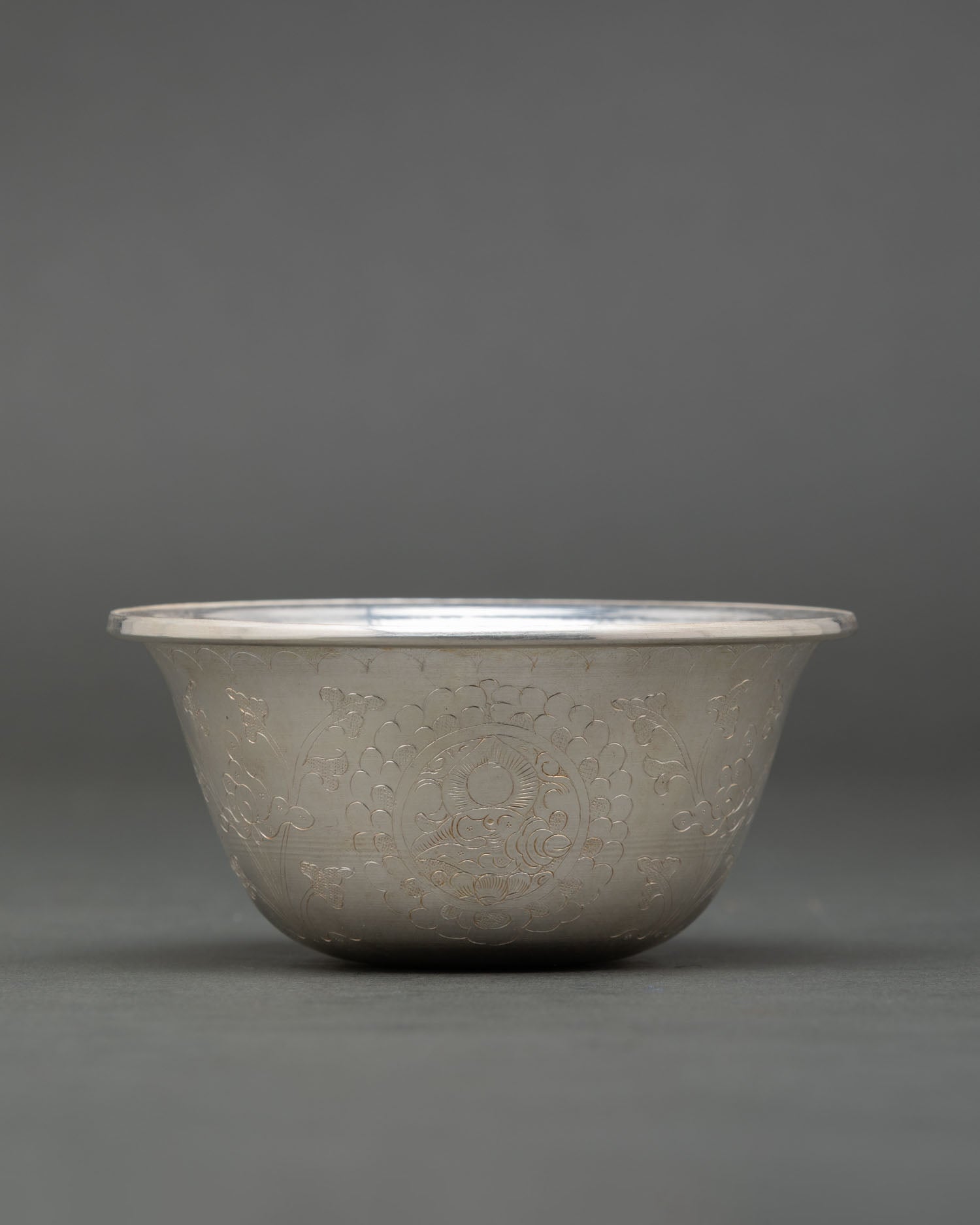 Close up pure silver Buddhist offering bowl handmade by Newari artisan from Patan Nepal