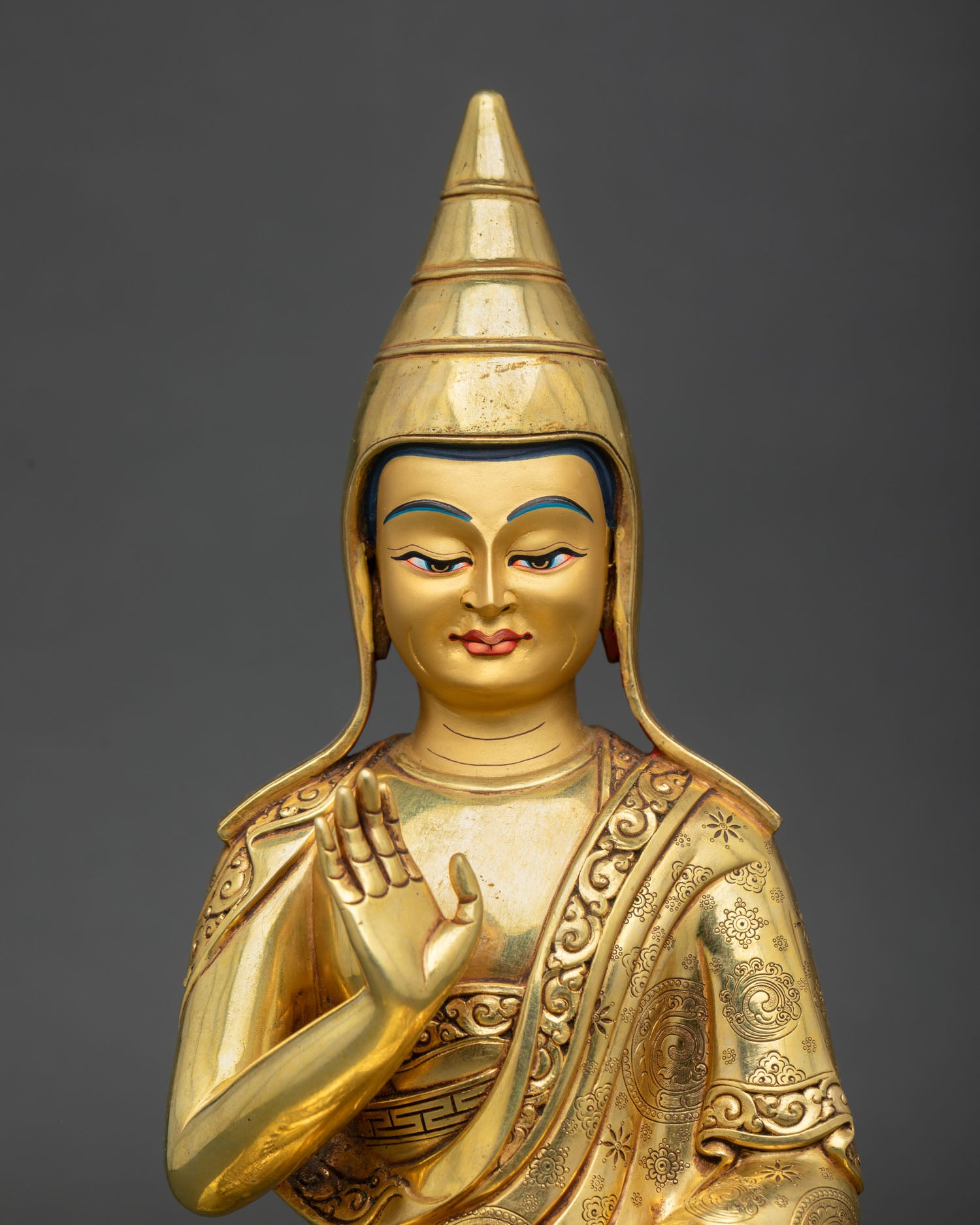 Close up Santaraksita face with monastic robes yellow lama hat and enlightened expression symbolizing wisdom and tranquility
