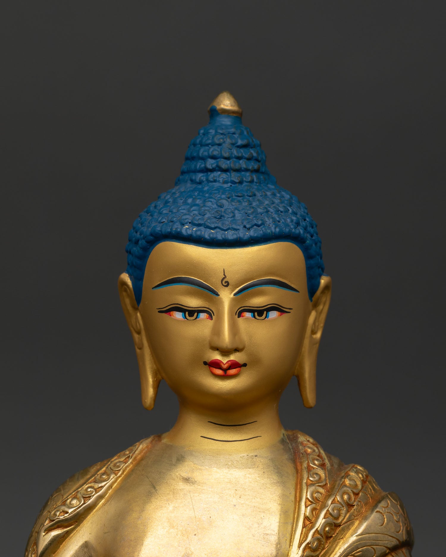 Close up Shakyamuni Buddha face detail gold painted serenity bhumisparsha mudra buddhist art