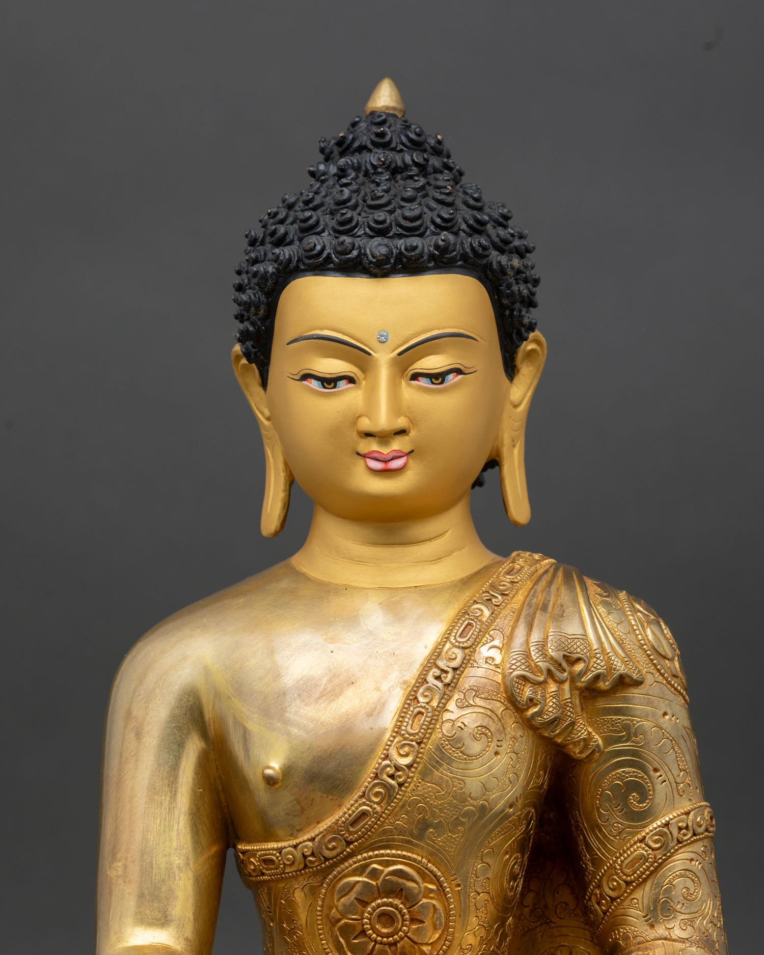 Close-up of Shakyamuni Buddha face, gold-painted, handcrafted Nepal