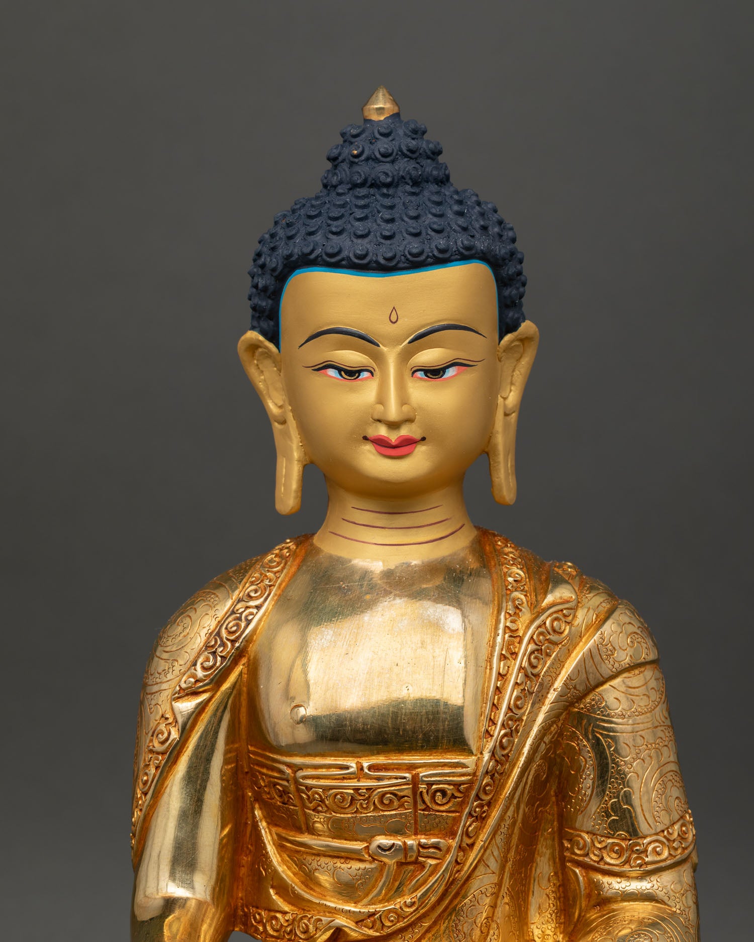 Close up Shakyamuni Buddha face gold-painted serene expression handcrafted Nepal