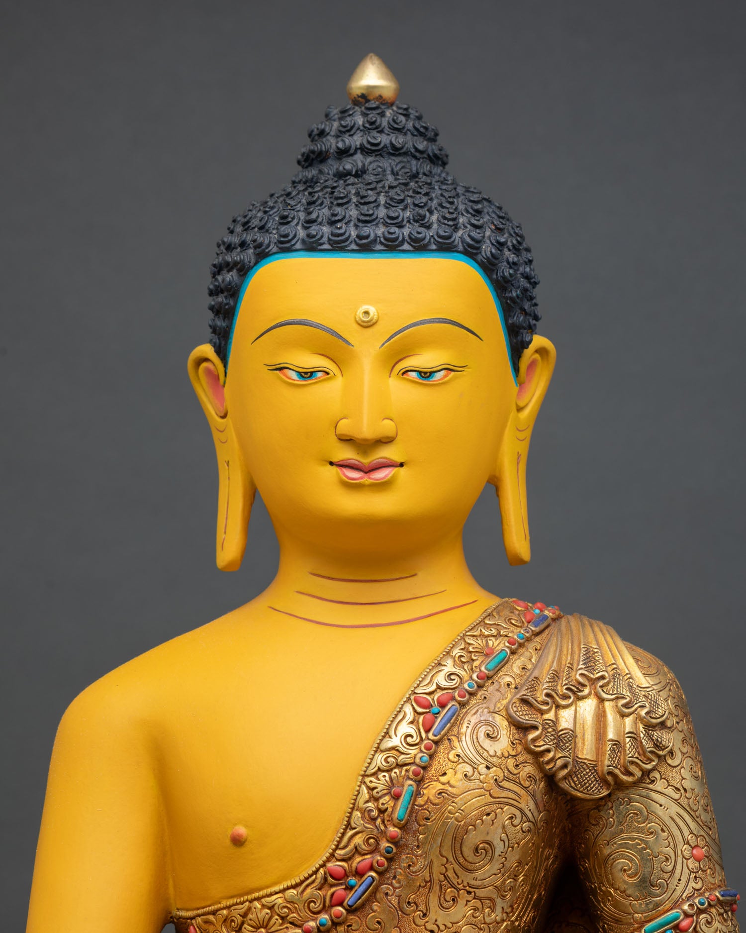 Close up Shakyamuni Buddha face with serene expression Bhumisparsha Mudra and Himalayan hand carved detailing for meditation space