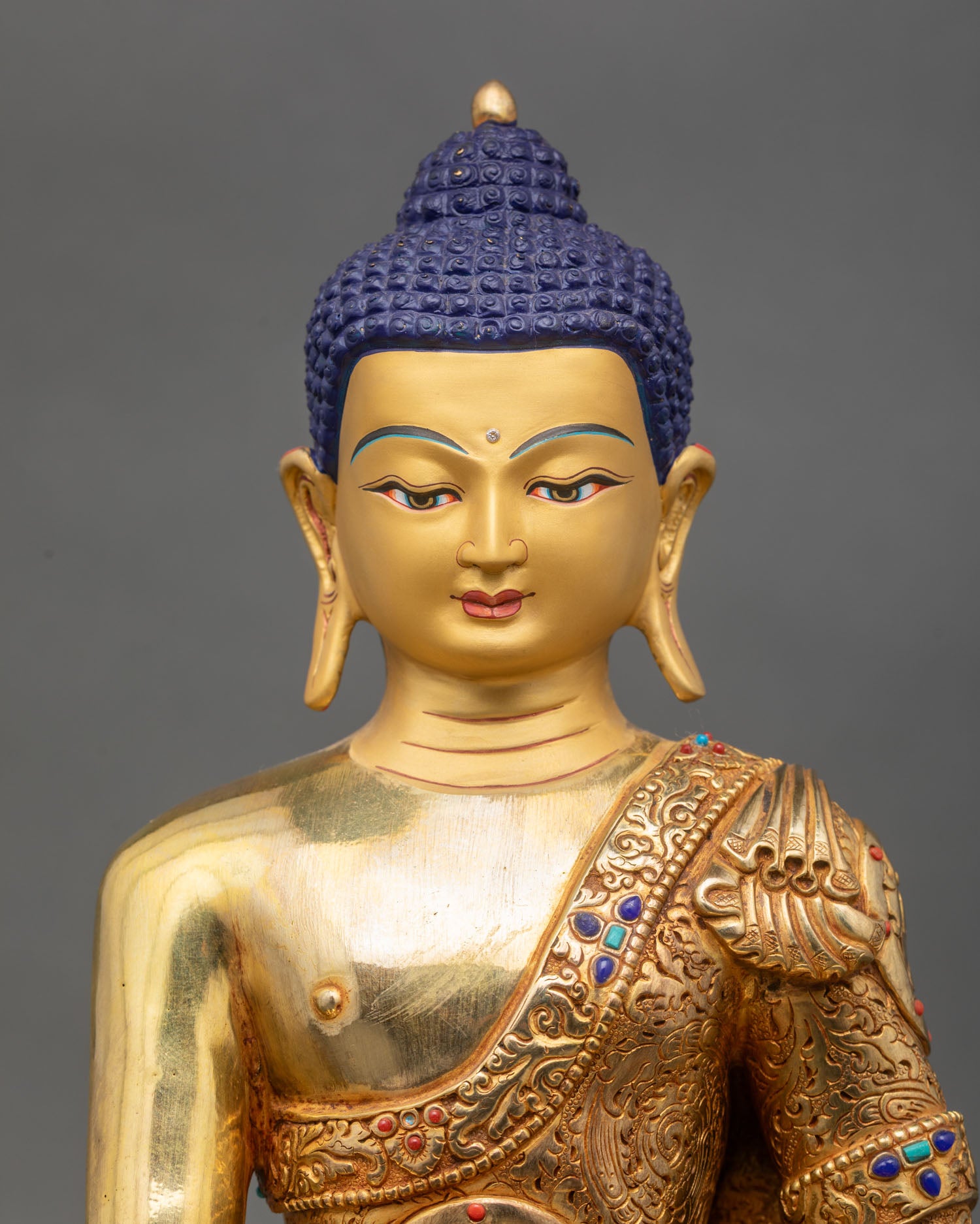 Close up Shakyamuni Buddha gold painted face Bhumisparsha mudra semi precious stones