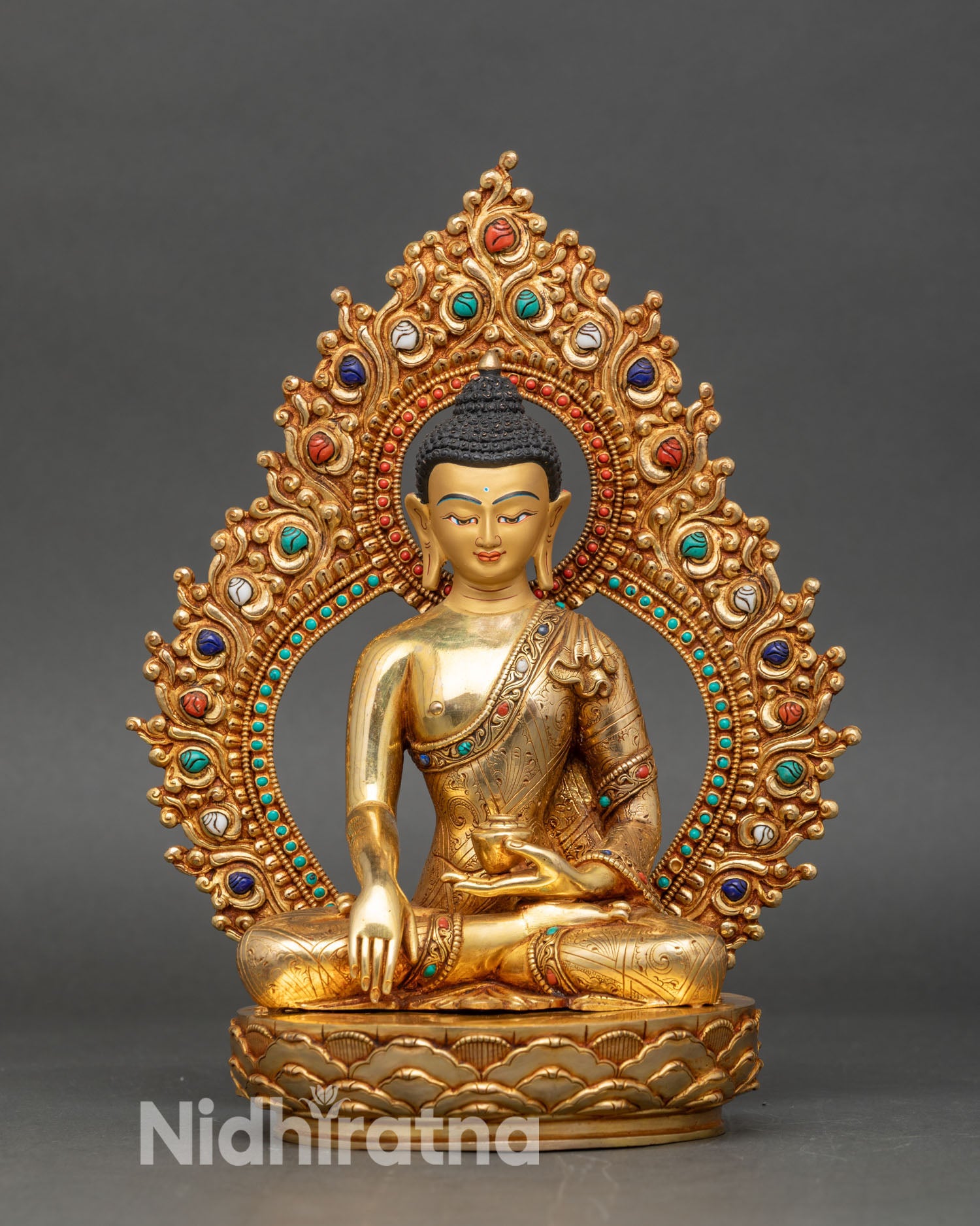Close up Shakyamuni Buddha gold painted face earth touching mudra patra bowl