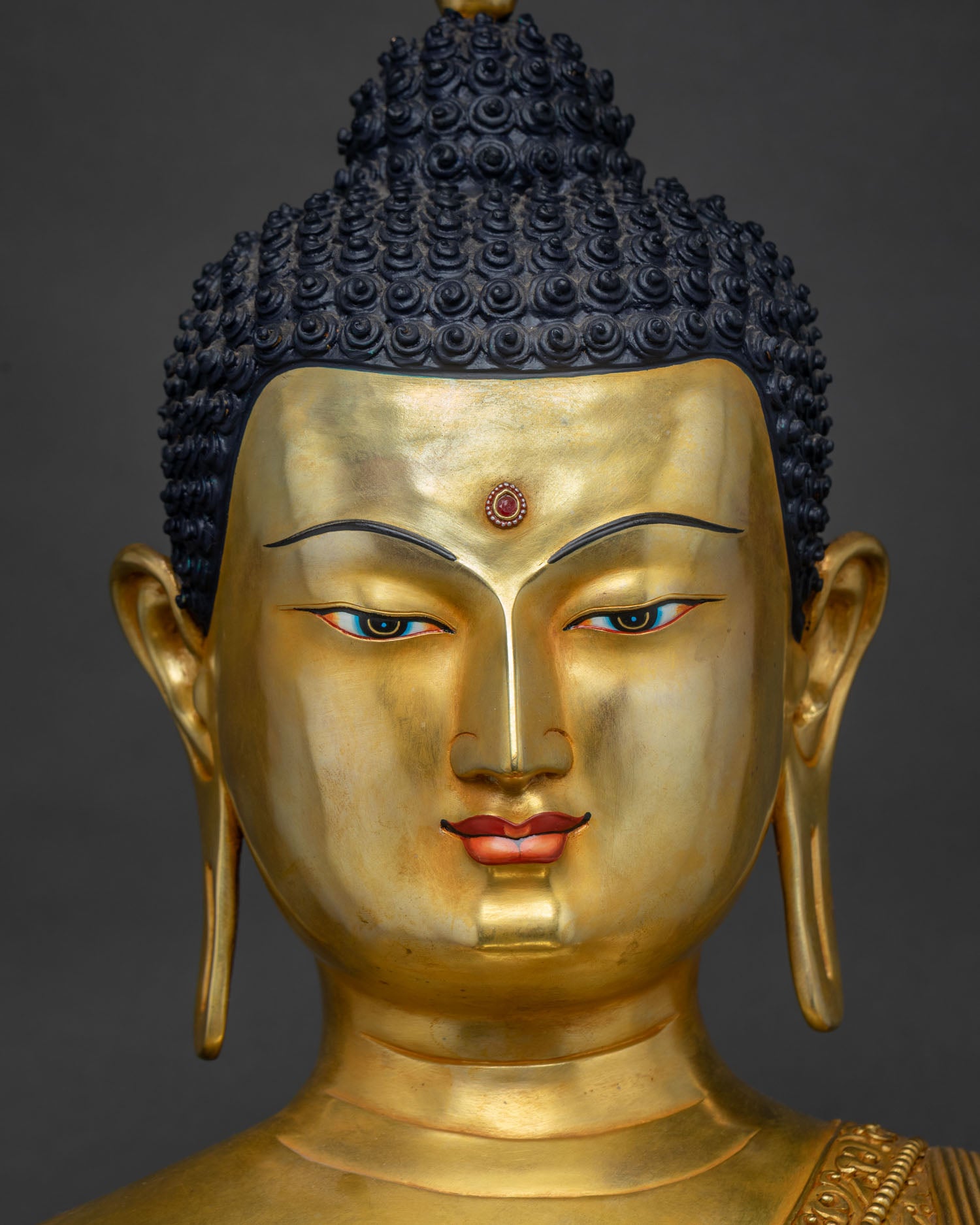 Close-Up of Shakyamuni Buddha's Serene 24K Gold-Painted Face