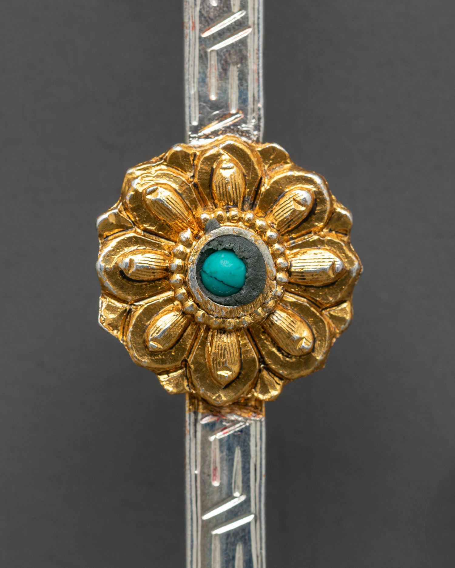 Close up tibetan spoon detailed engraving meander pattern turquoise vajrayana ritual craftsmanship kathmandu valley