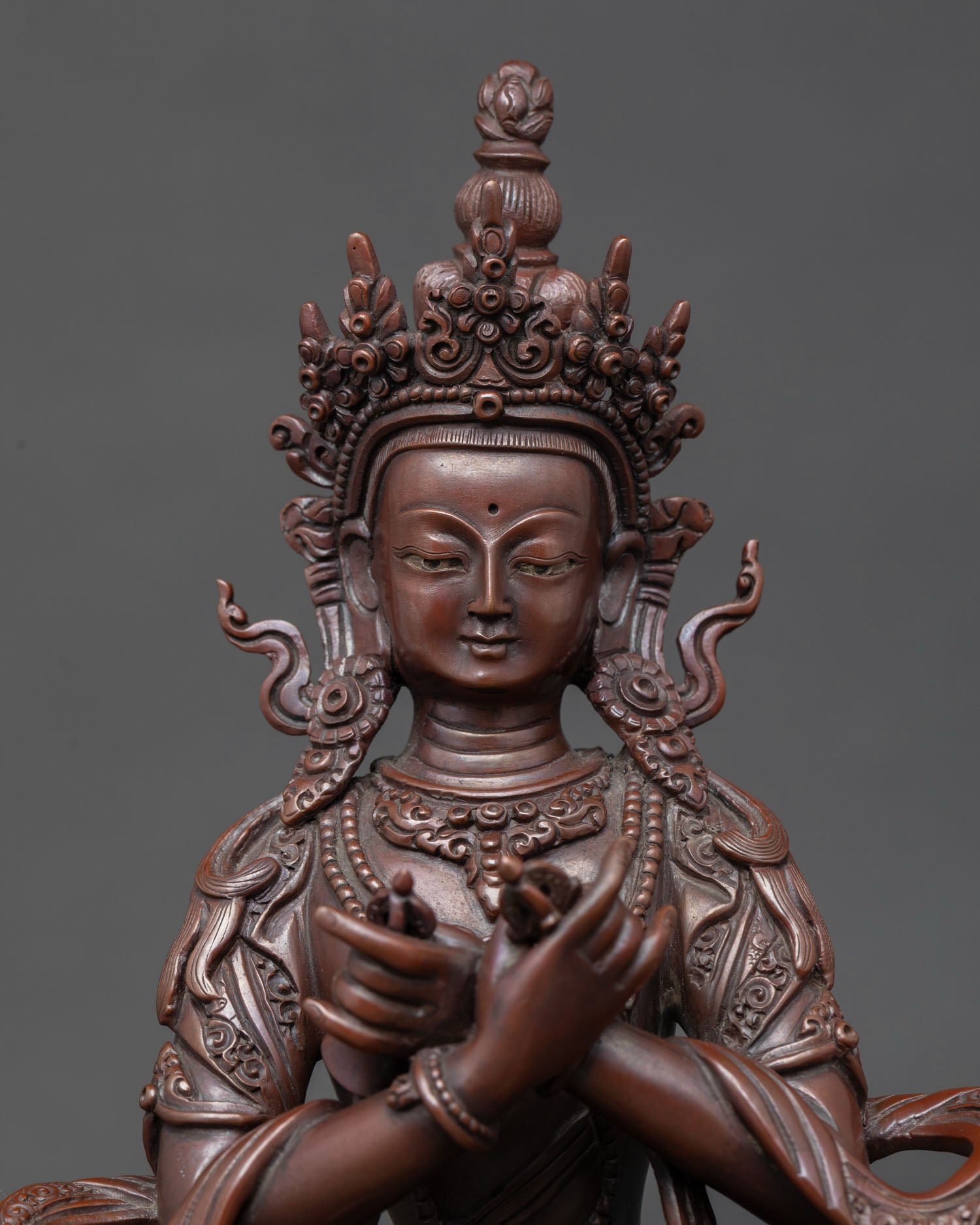 Close-up Vajradhara Adi Buddha statue showing a serene expression, intricate Newari craftsmanship