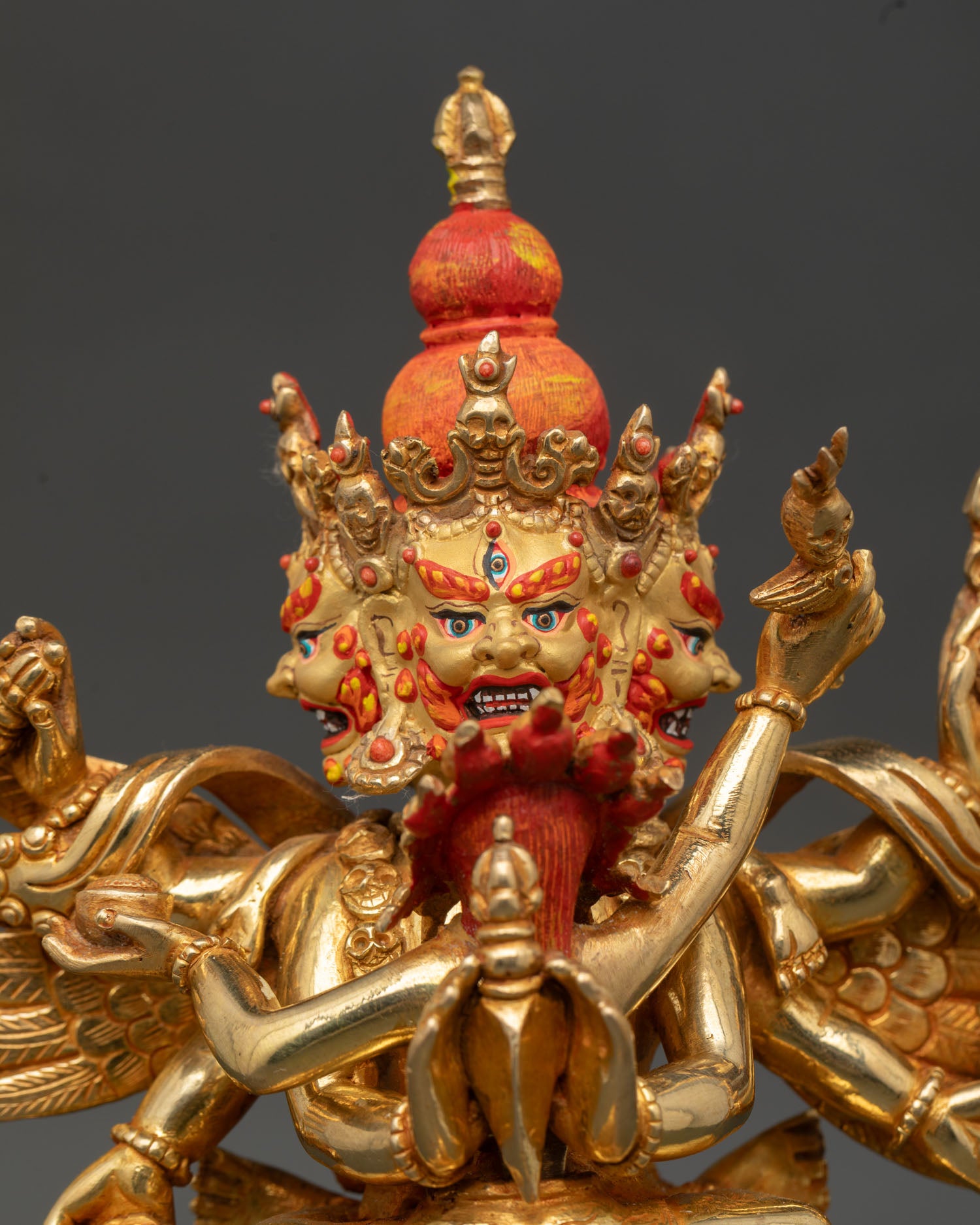 Close up Vajrakilaya statue gold painted face coral stone detail Newari artisan craftsmanship Vajrayana wrathful deity spiritual art