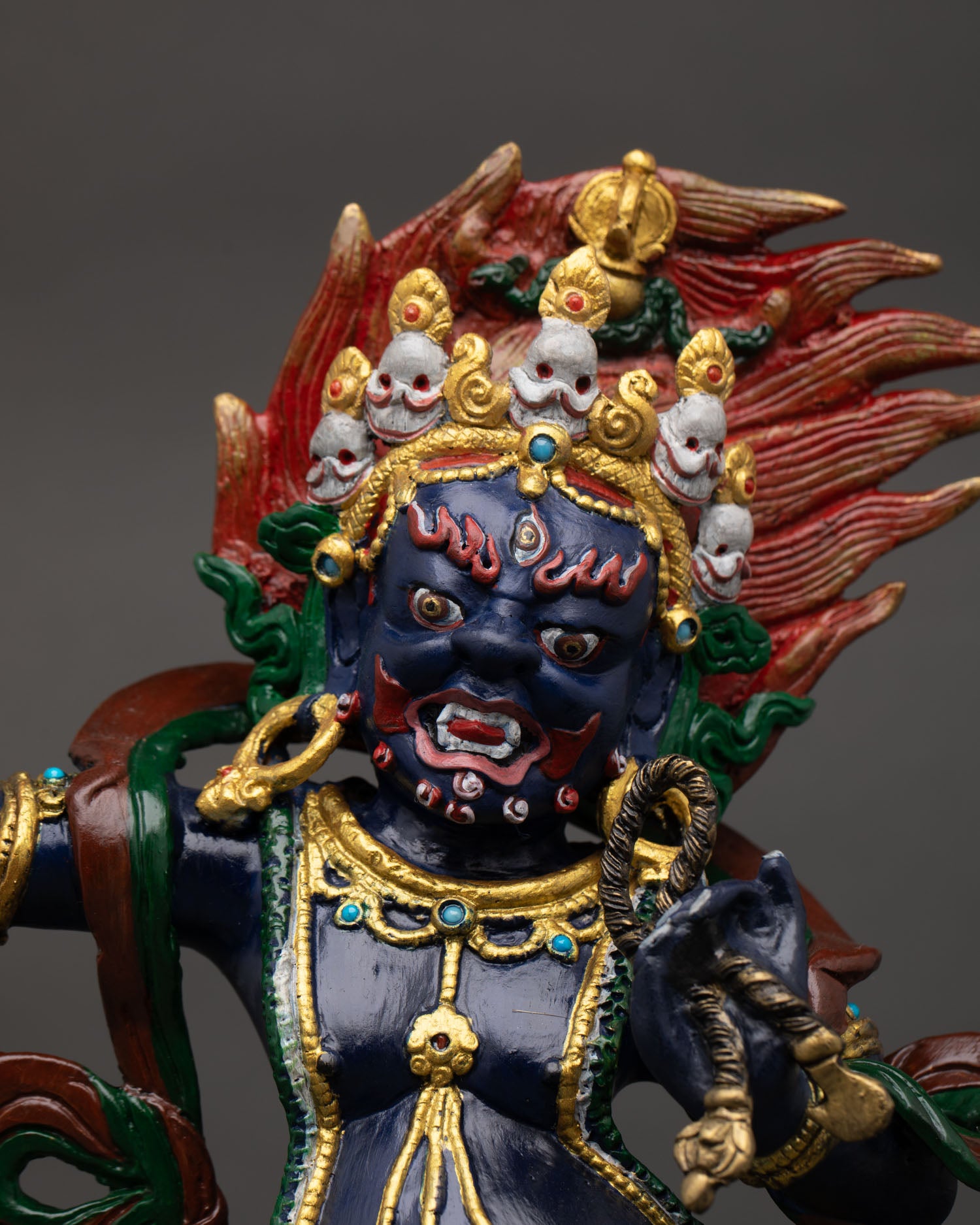 Close up Vajrapani face detail expressive wrathful expression flowing hair Himalayan Buddhist deity sculpture