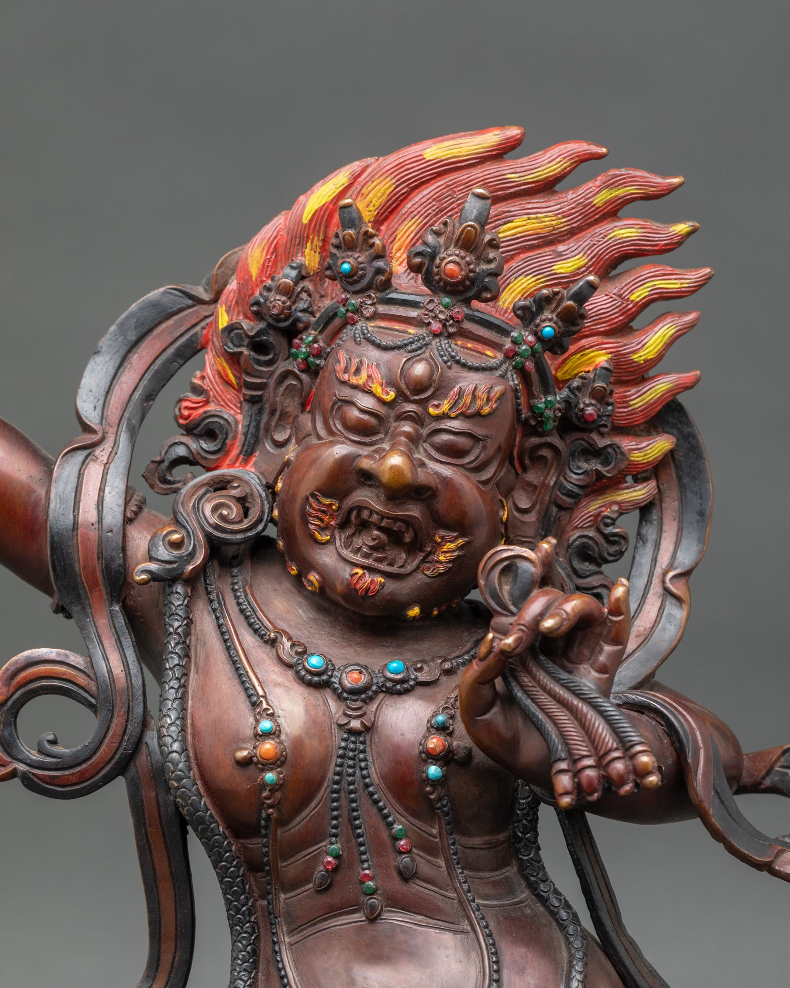 Close-up Vajrapani face fierce expression mace deity Himalayan sculpture