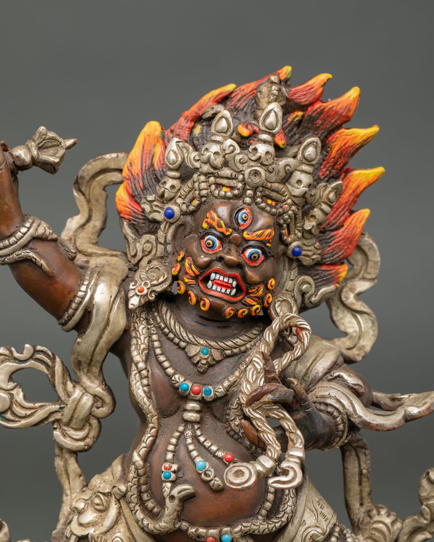 Close up Vajrapani face wrathful expression vajra flame hair Himalayan Buddhist sculpture