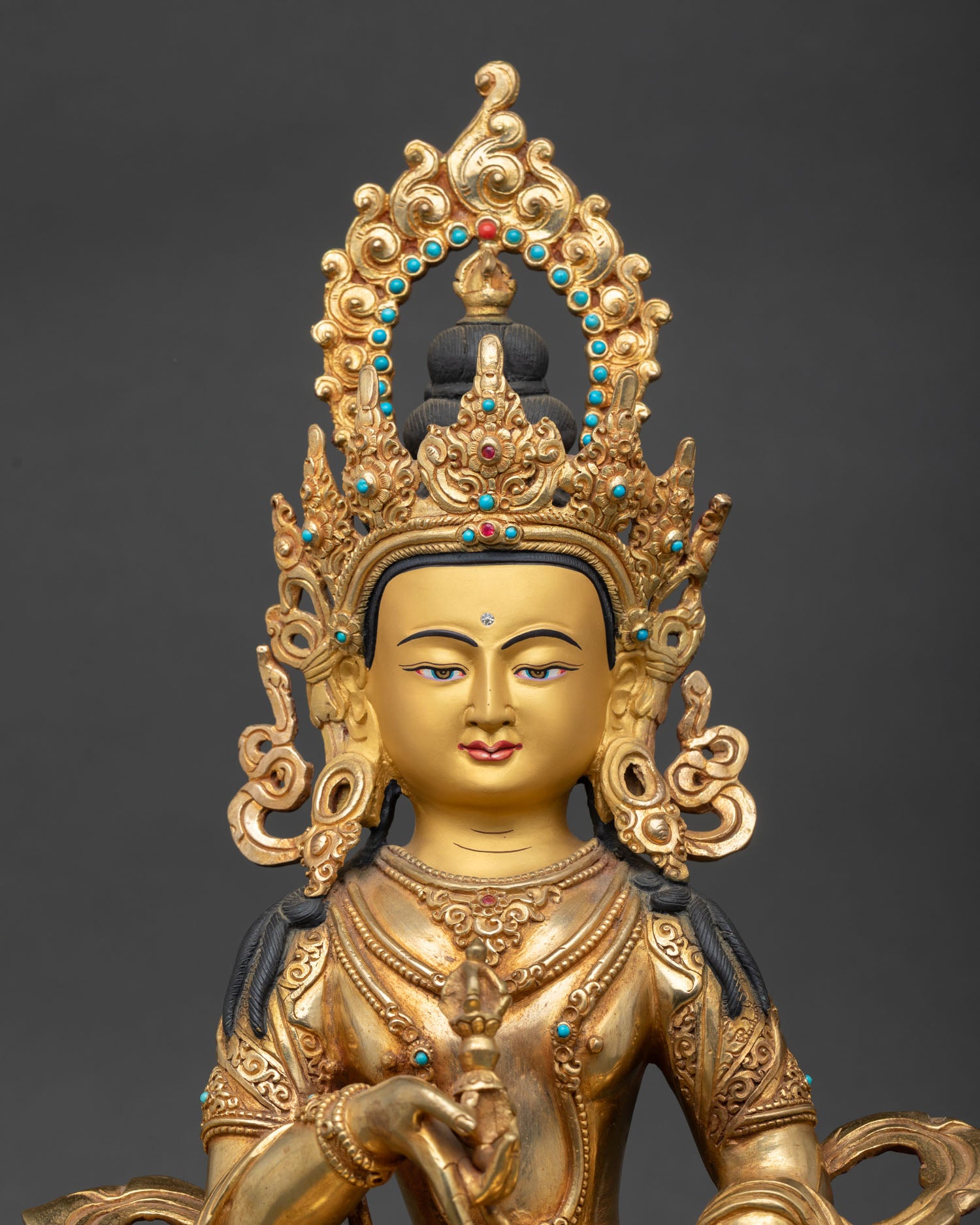Close up Vajrasattva, face gold painted detailing semi precious stones Himalayan Buddhist craftsmanship sacred expression meditation statue